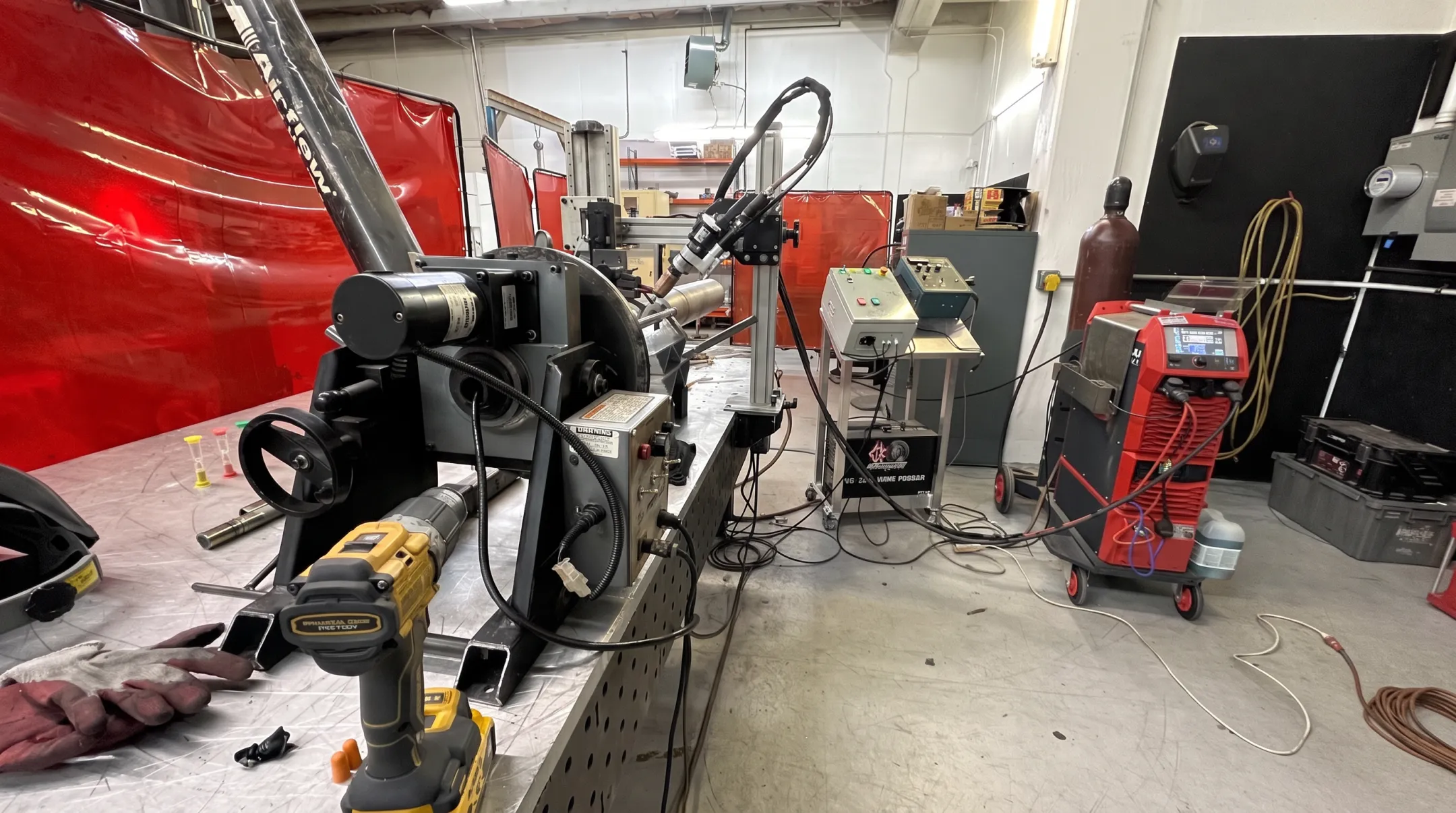 Rotating welding fixture with adjustable torch holder on orbital system