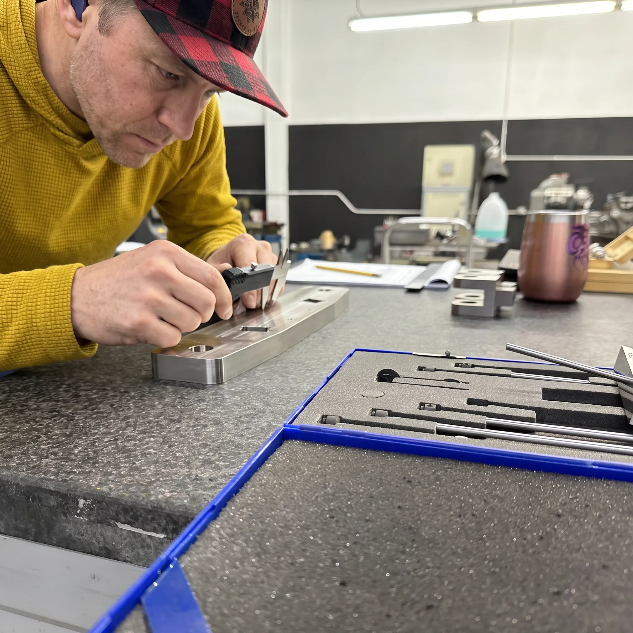 Technician inspecting a precision metal component