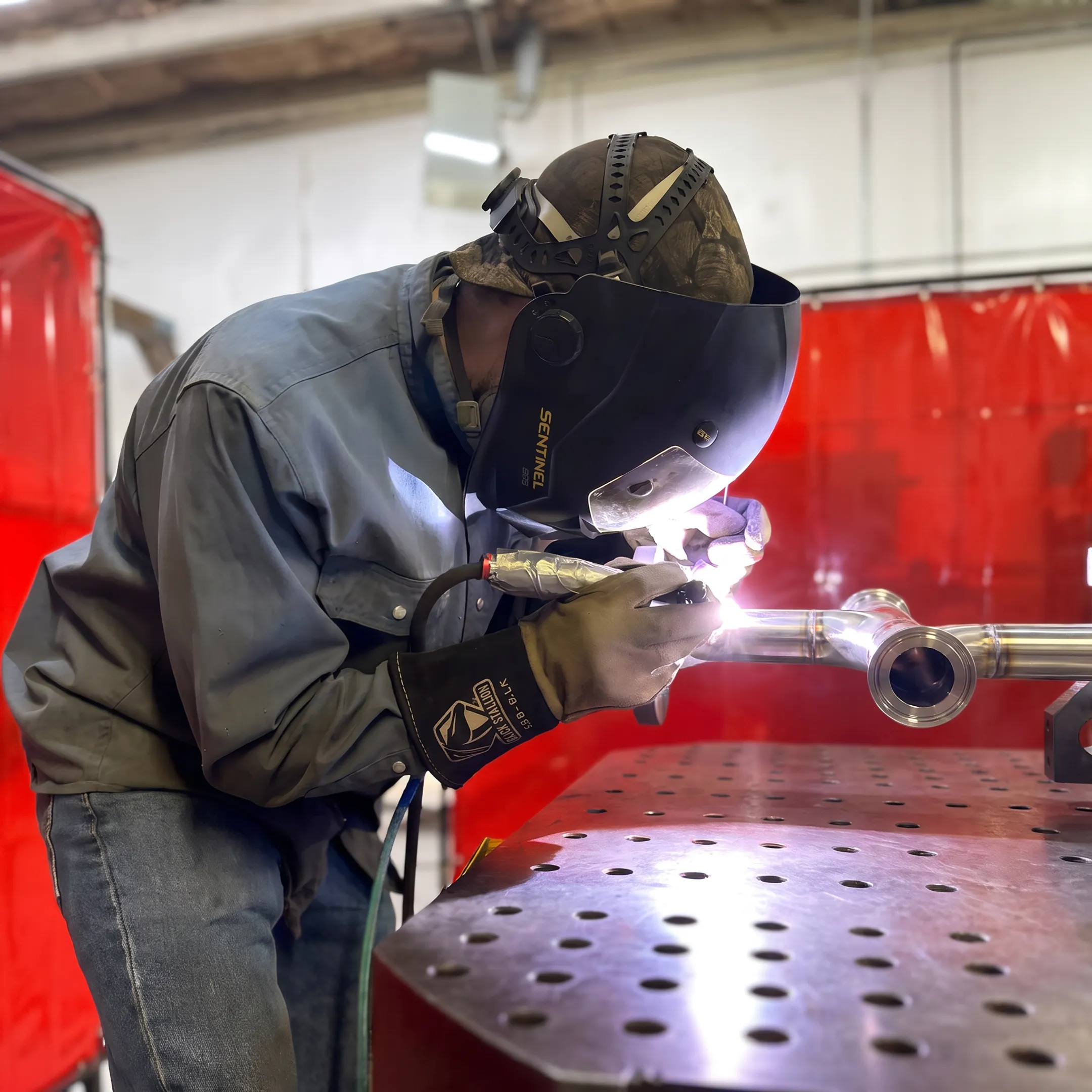 Welder fabricating a sanitary stainless steel piping system