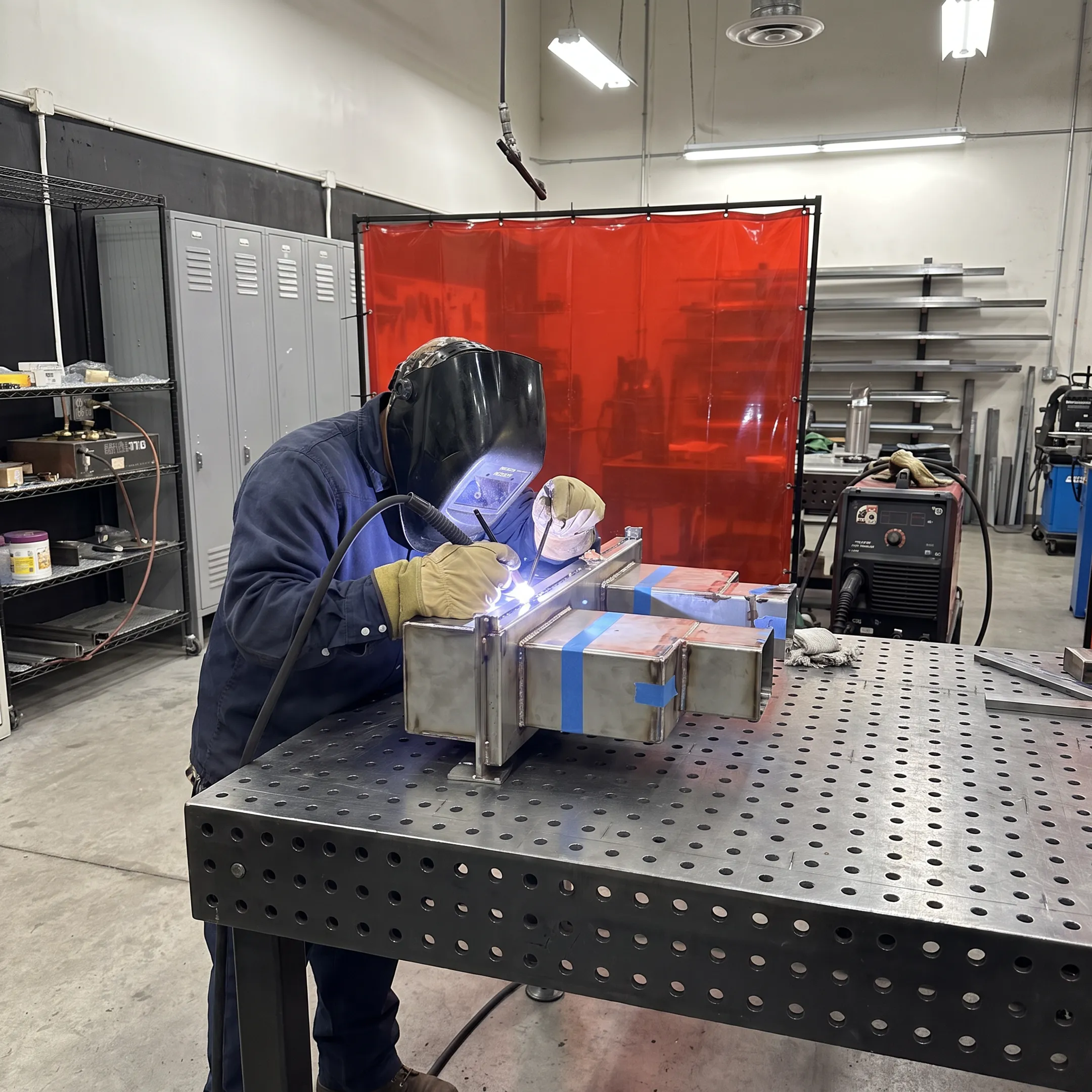 Technician welding a precision nuclear fabrication assembly