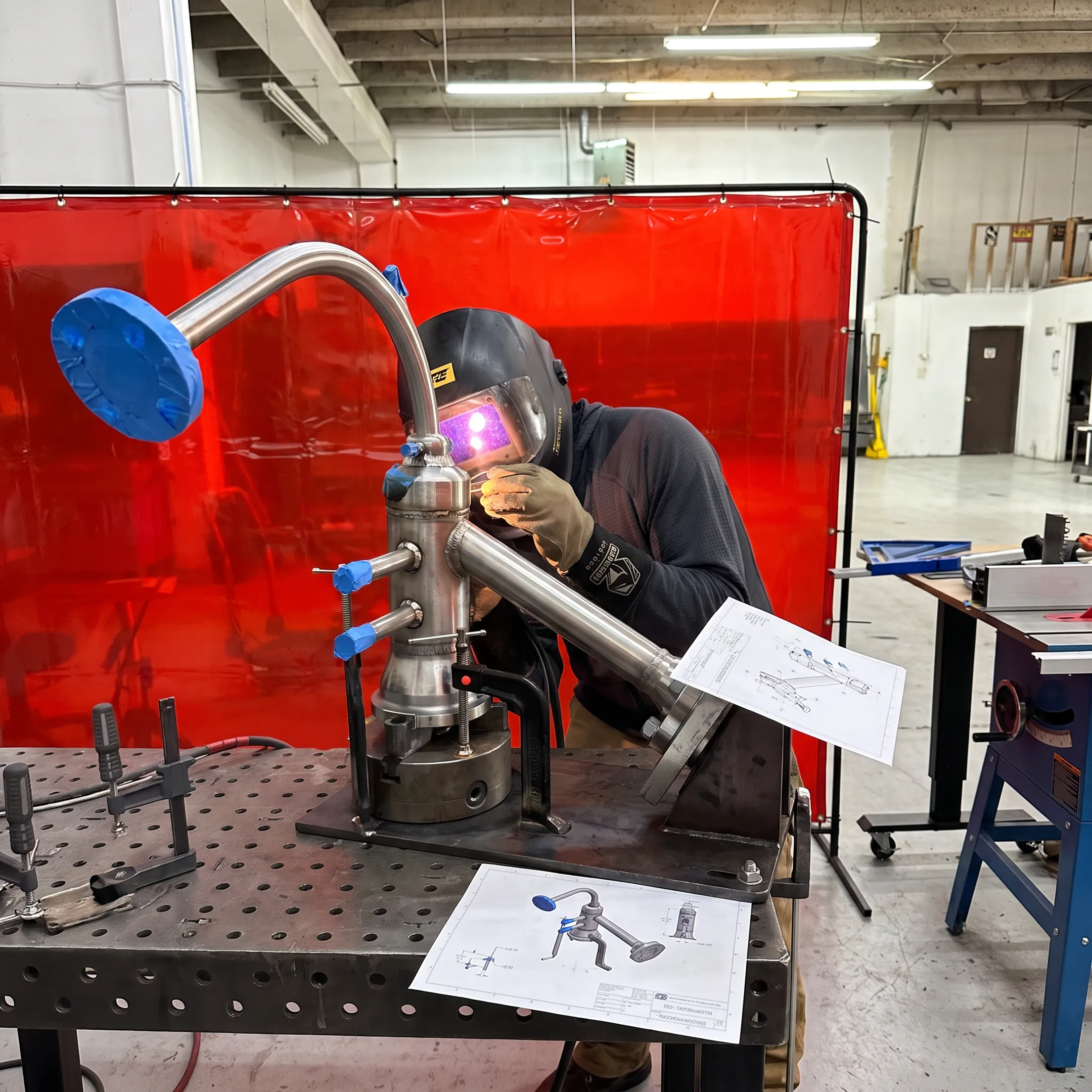 Welder creating a precise custom metal assembly in a fabrication shop