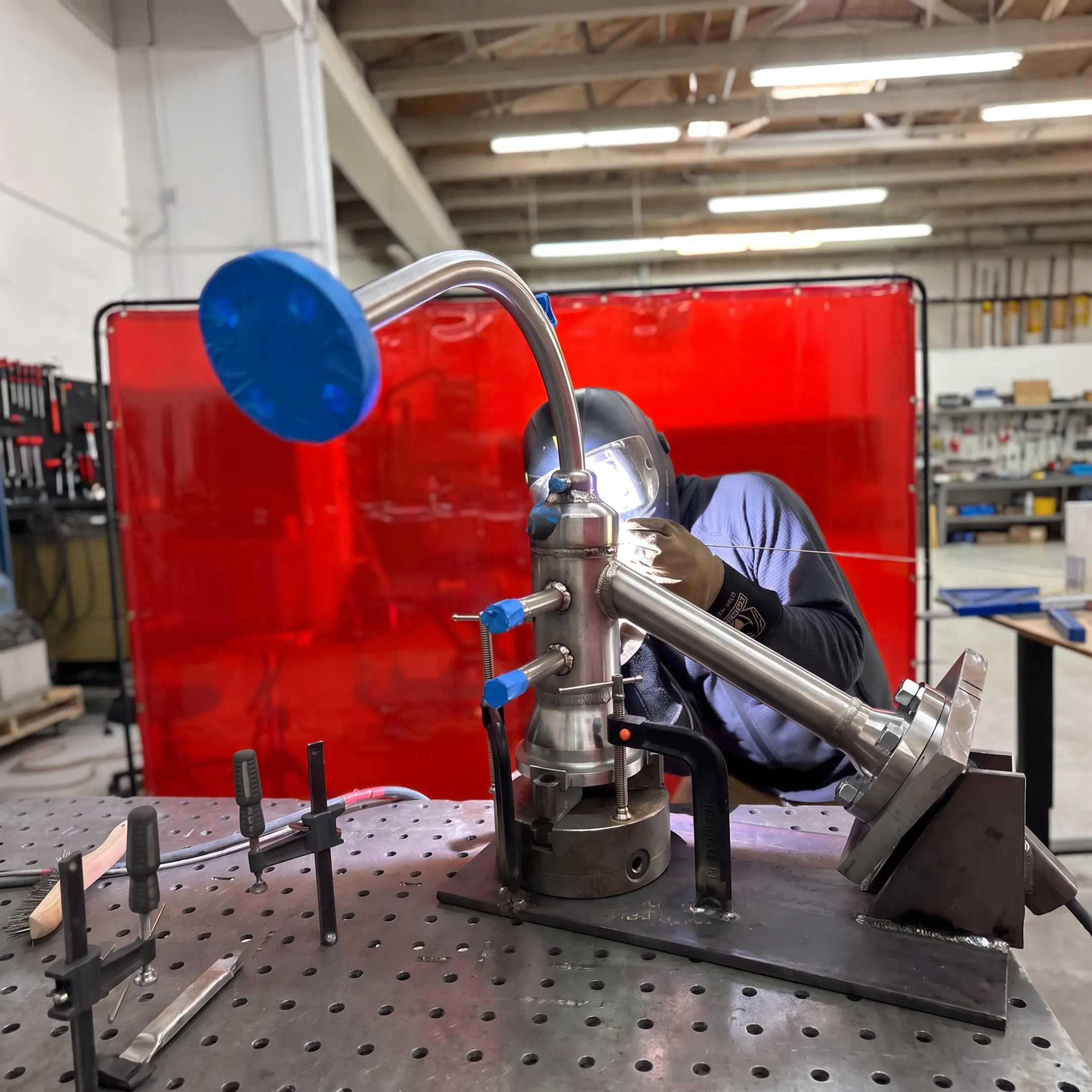 Welder fabricating stainless steel industrial piping