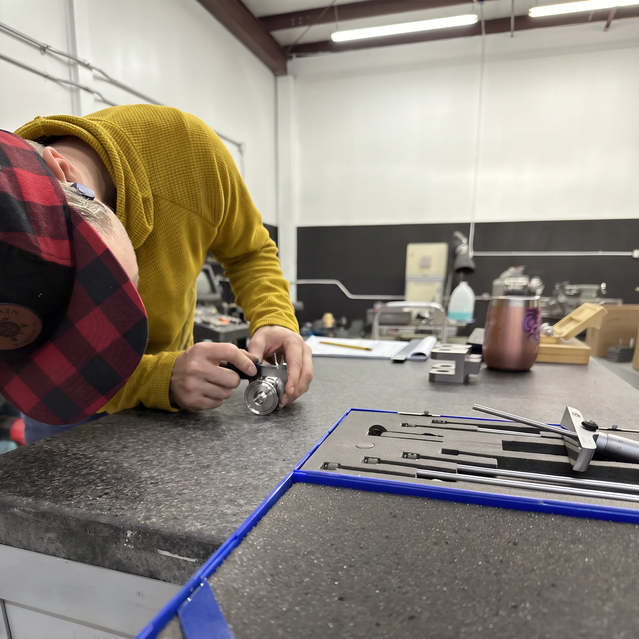 Technician inspecting a precision-welded medical component