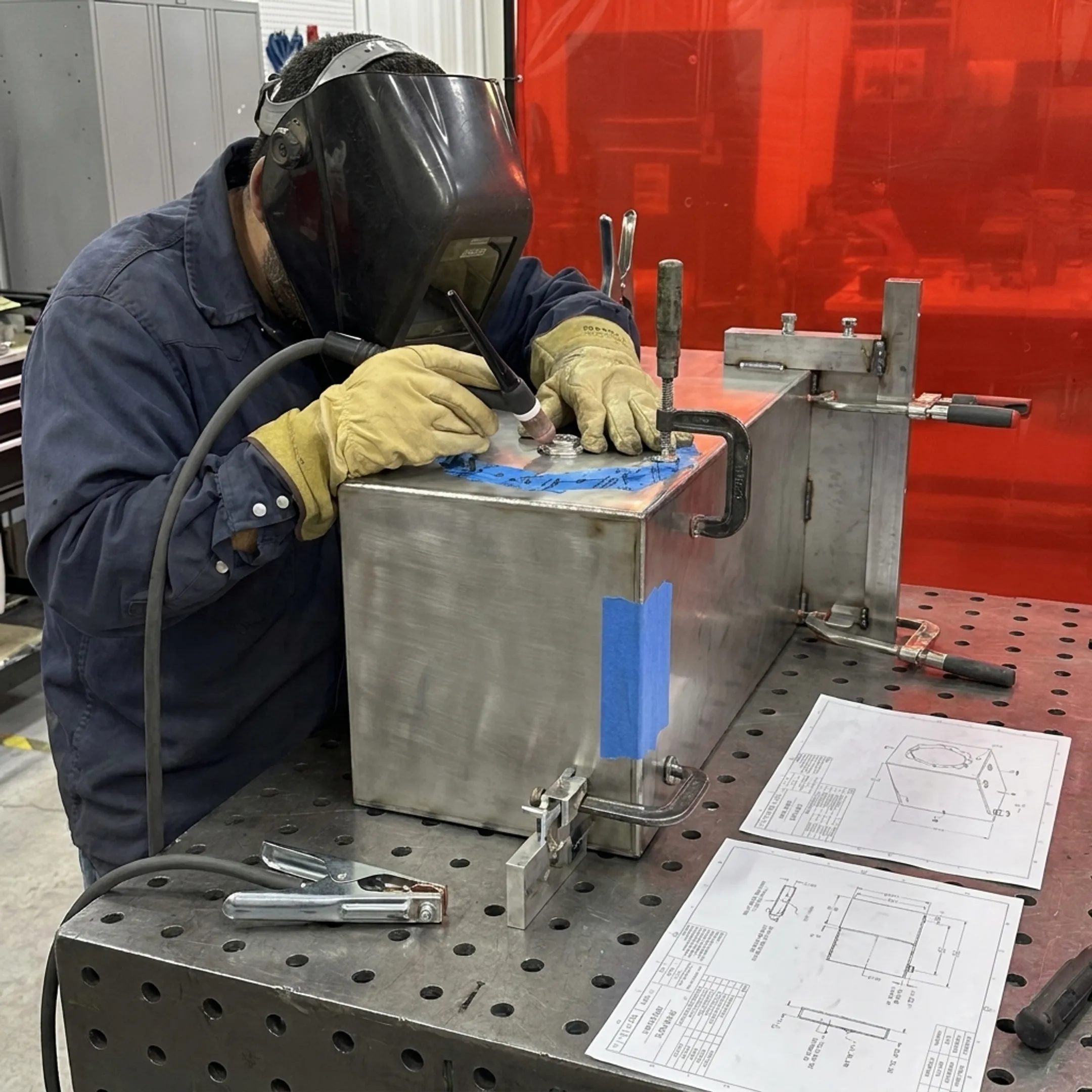 Custom welded equipment enclosure assembly on a fabrication workbench