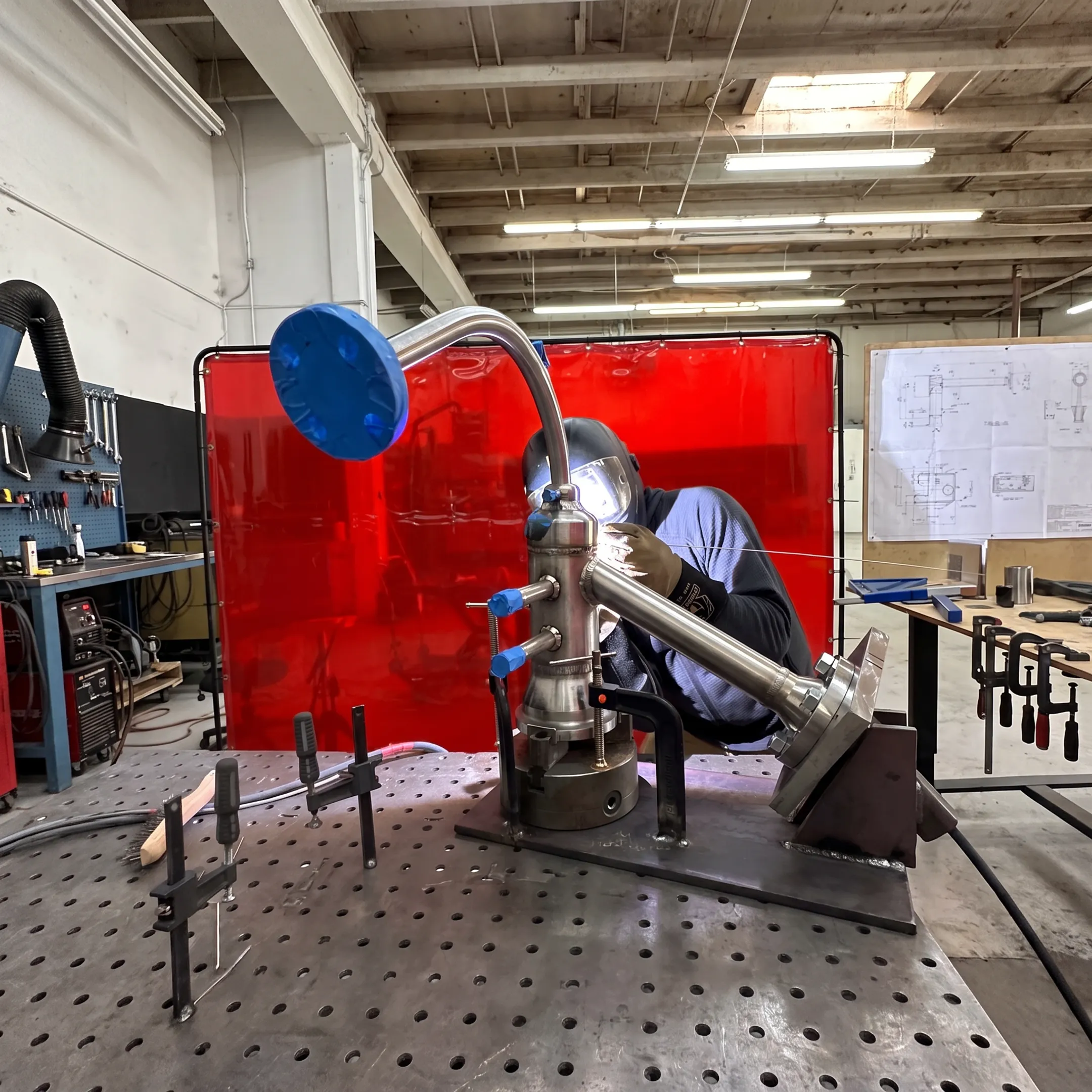 Precision fabrication team welding a cryogenic-industry metal assembly