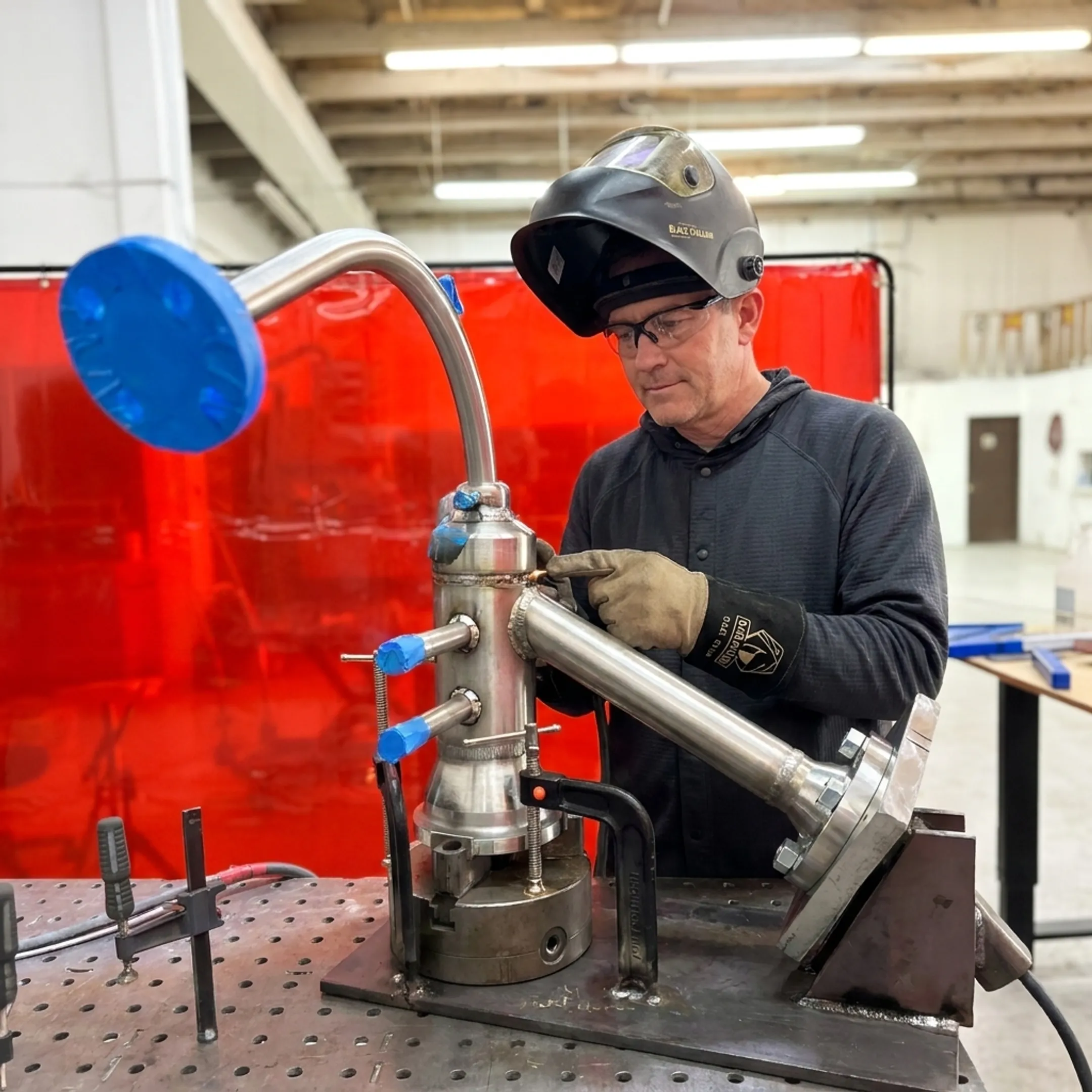 Technician inspecting a repeatable welded assembly