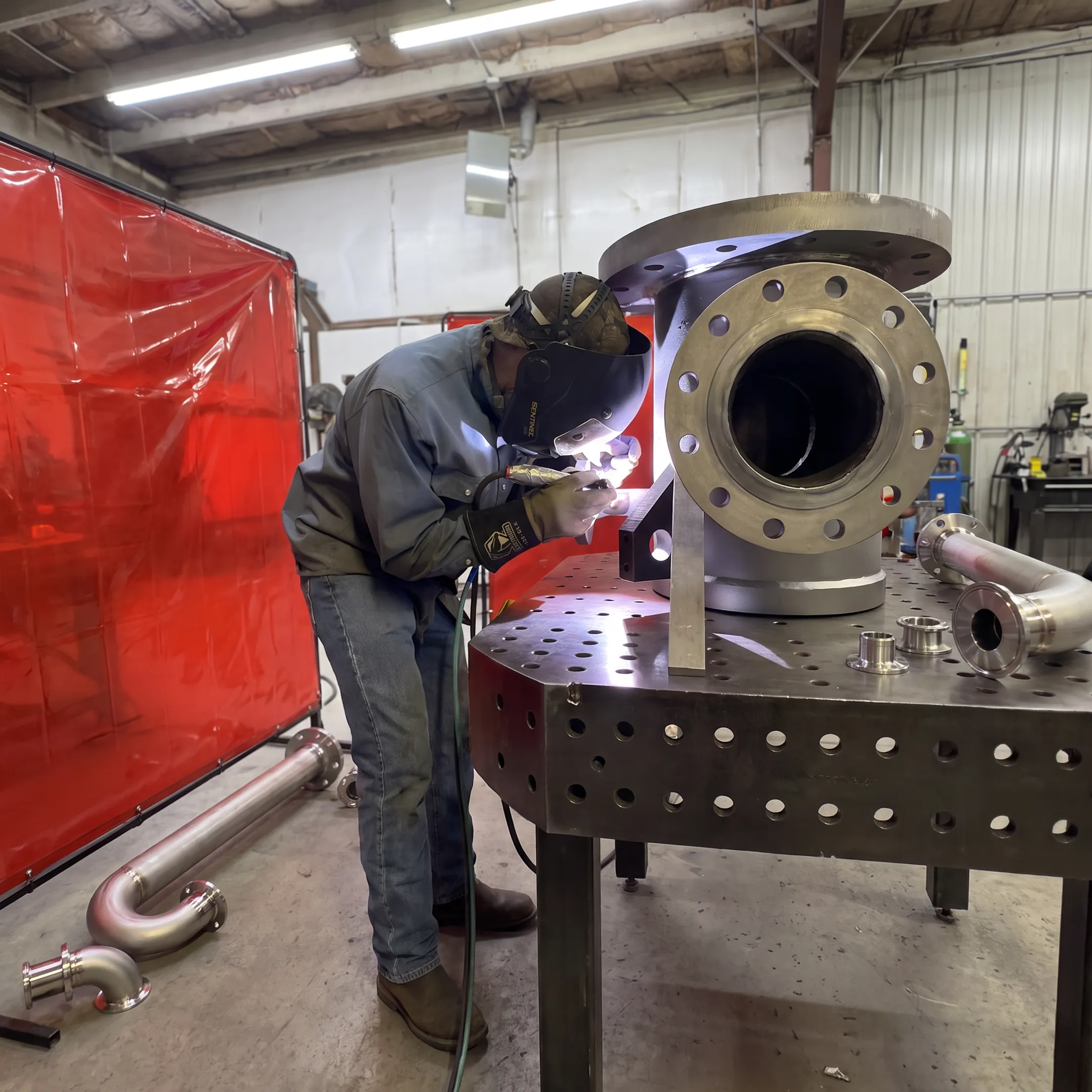 Precision process piping materials being welded in a controlled fabrication shop