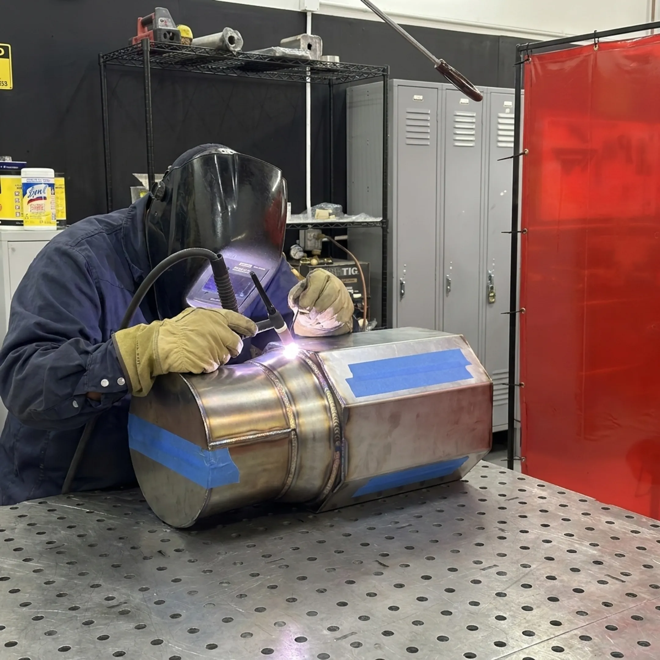 Technician TIG welding a custom specialty-alloy component