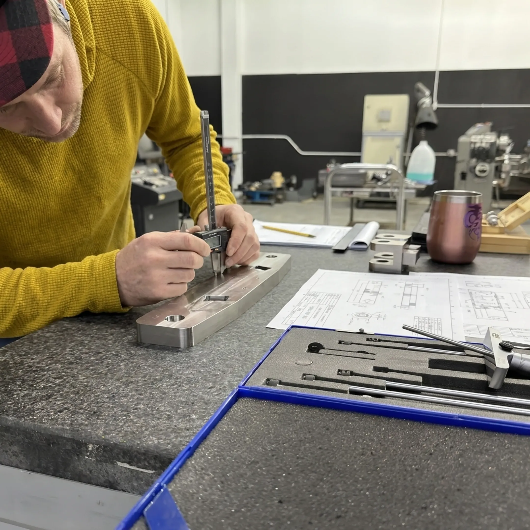 Technician inspecting a custom welded metal component