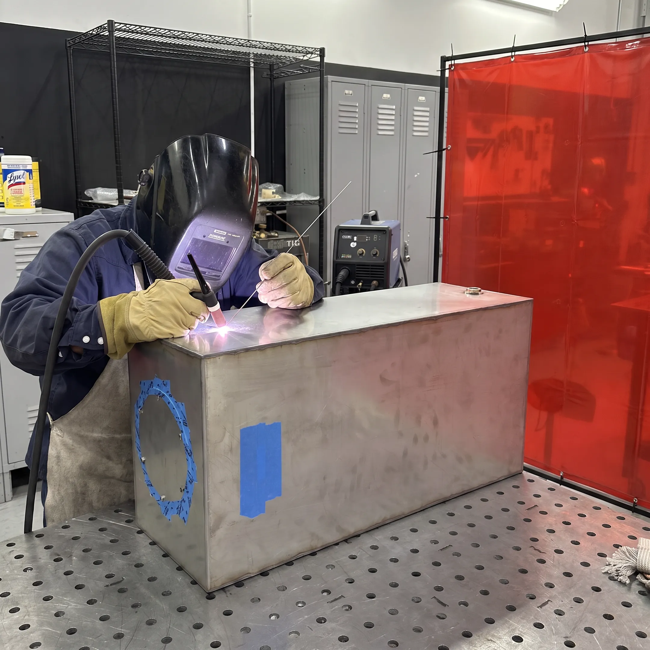 Welder performing precision mobile welding on a stainless steel assembly
