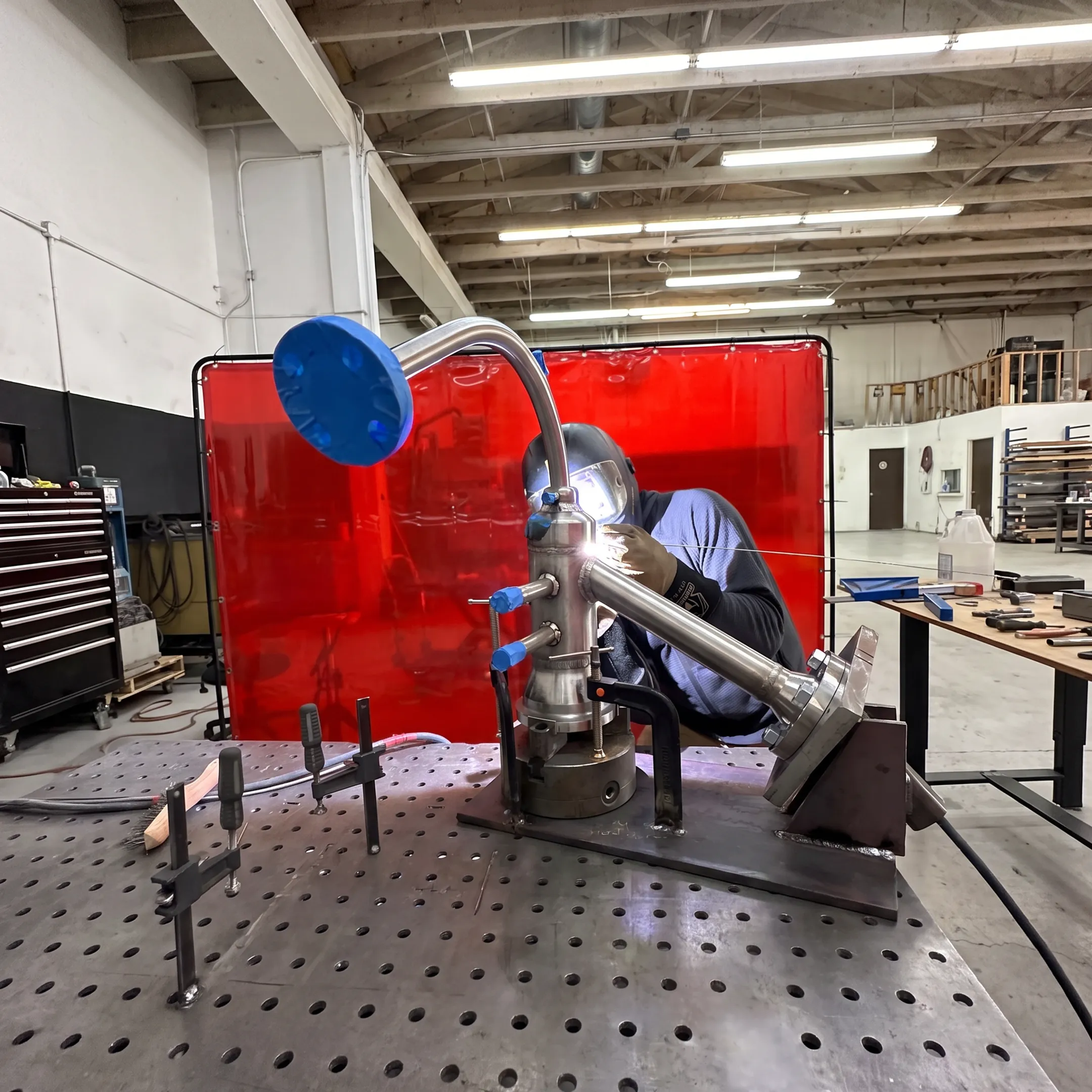 Precision laser metal fabrication in a controlled workshop