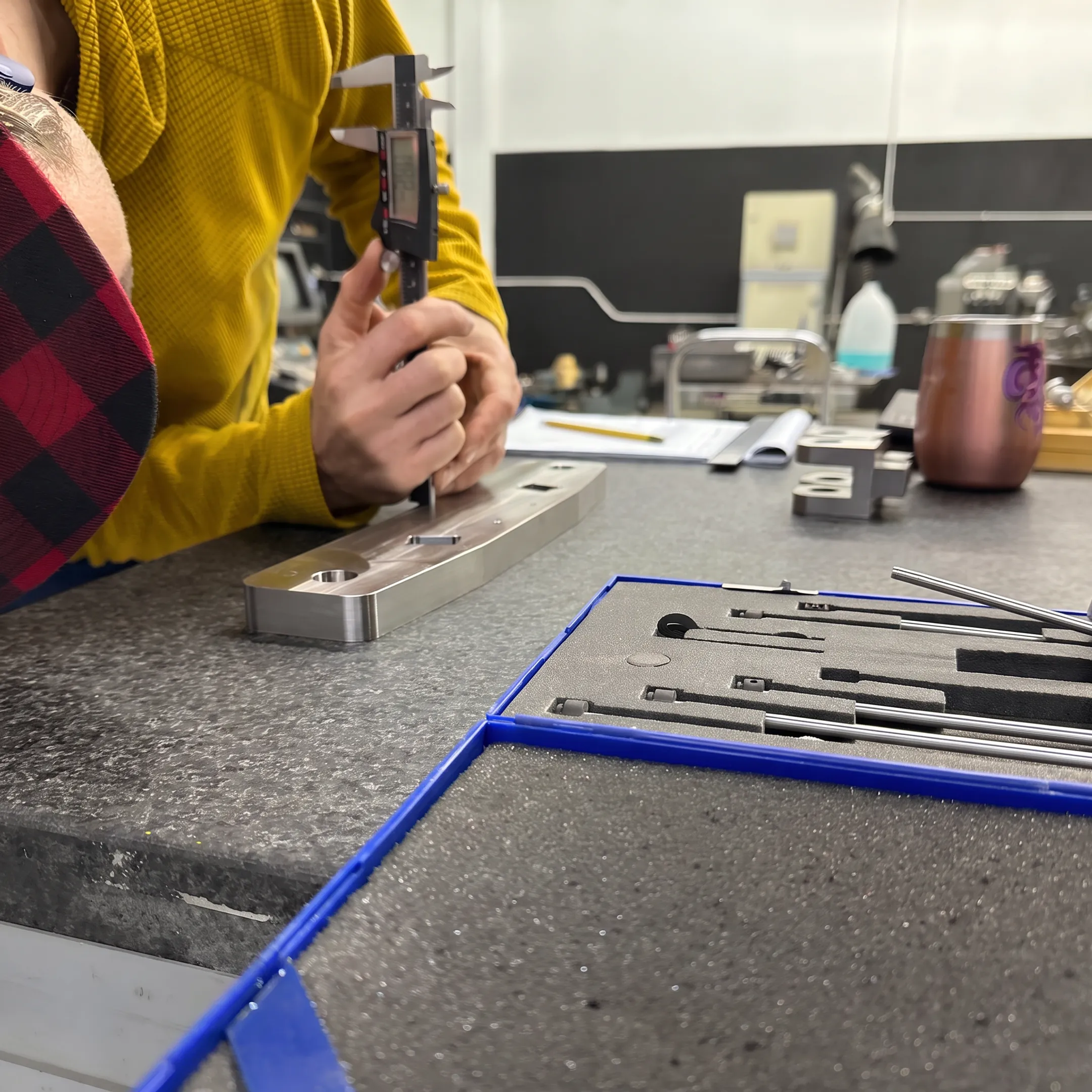 Fabricator inspecting a welded stainless steel scrubber component