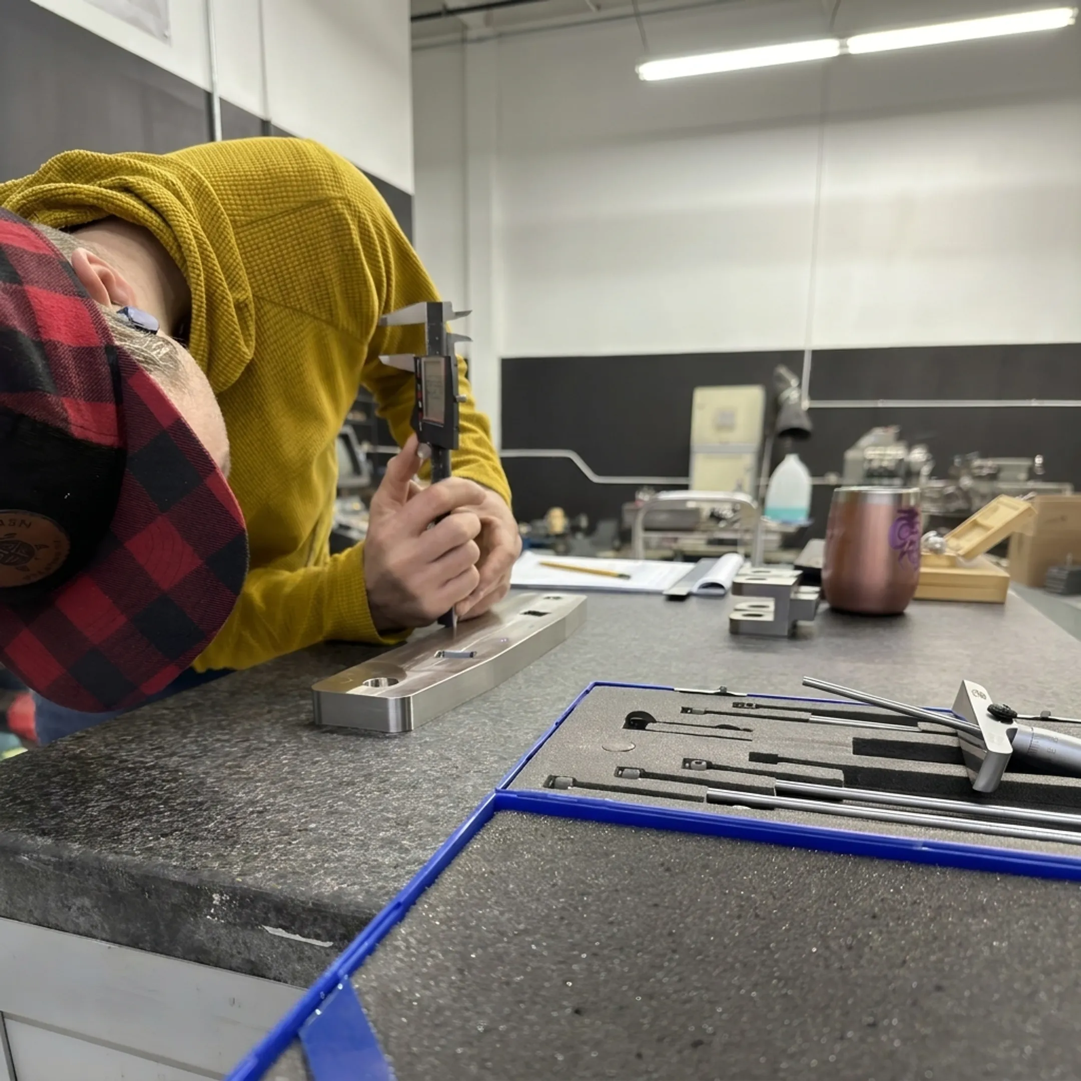 Technician inspecting a precision welded metal component