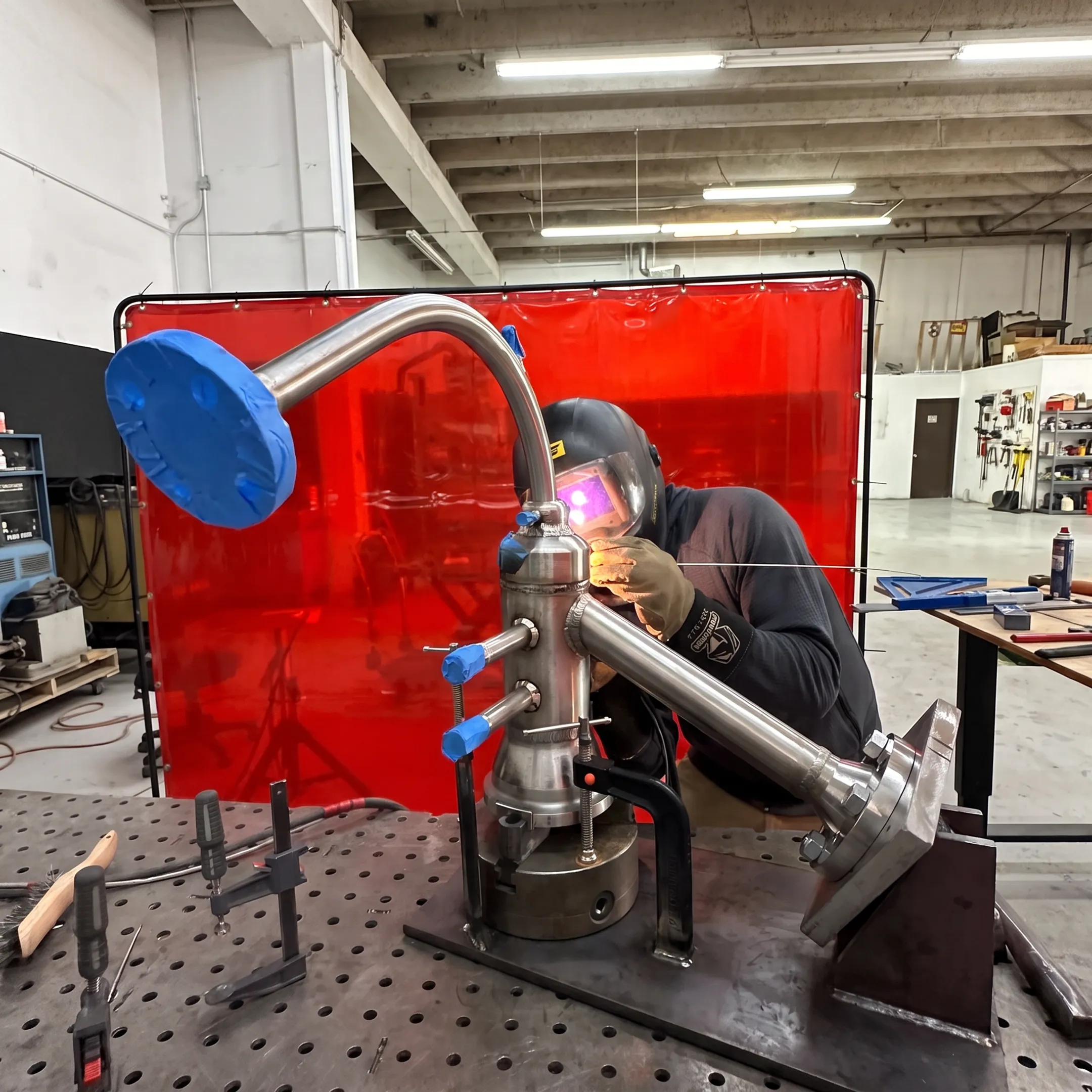 Welder performing precision fusion welding on a fabricated metal assembly