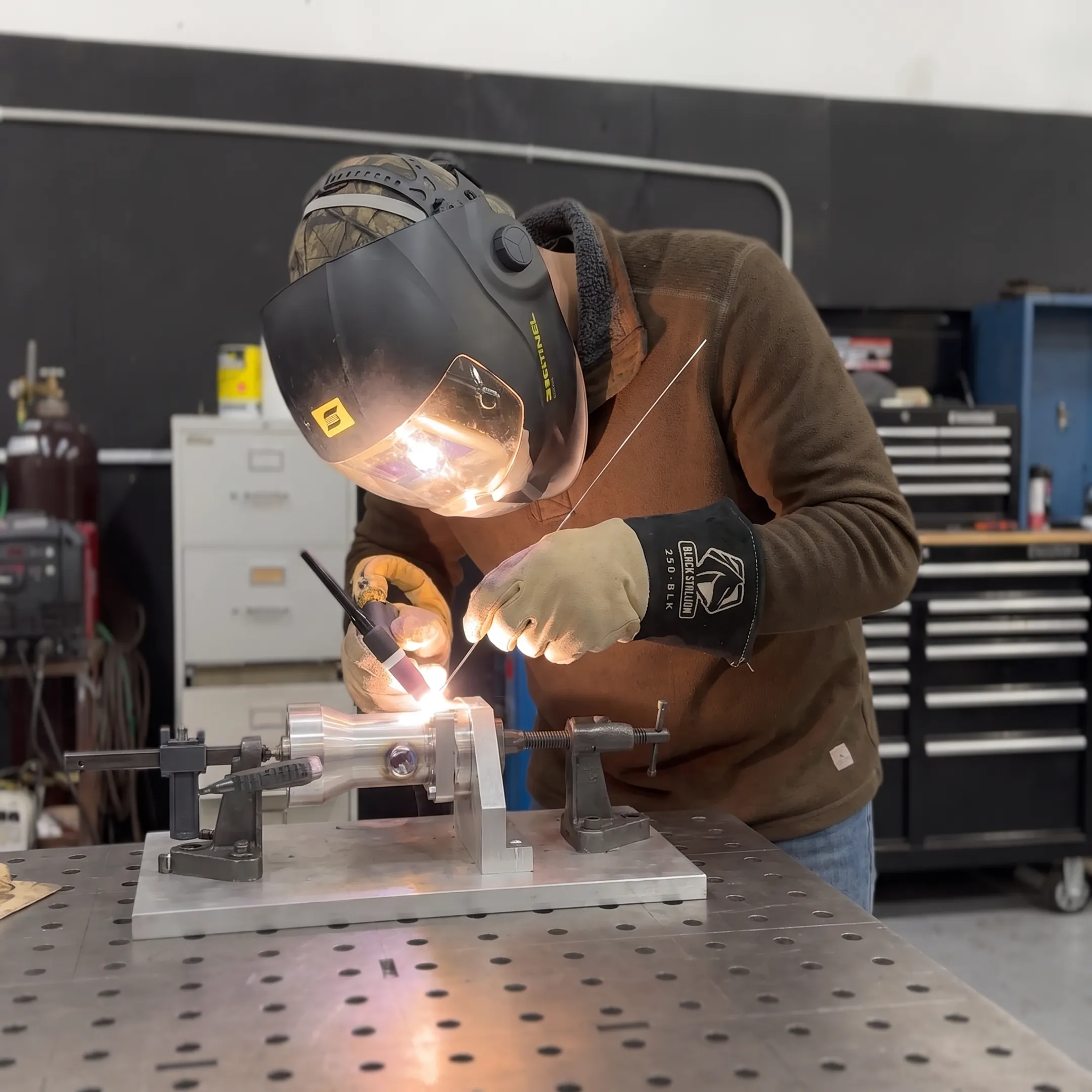 Technician TIG welding a specialty alloy component