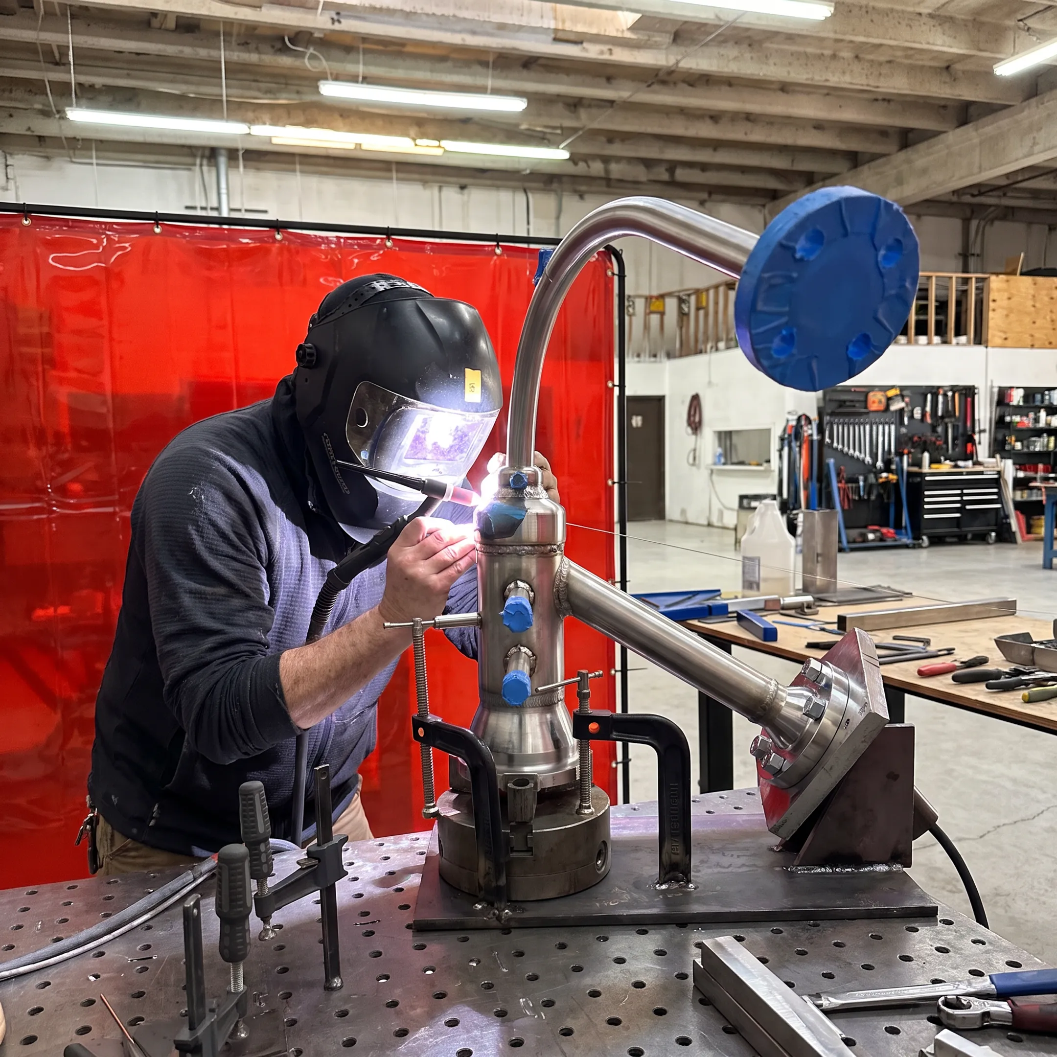 Welder fabricating a precision industrial metal assembly