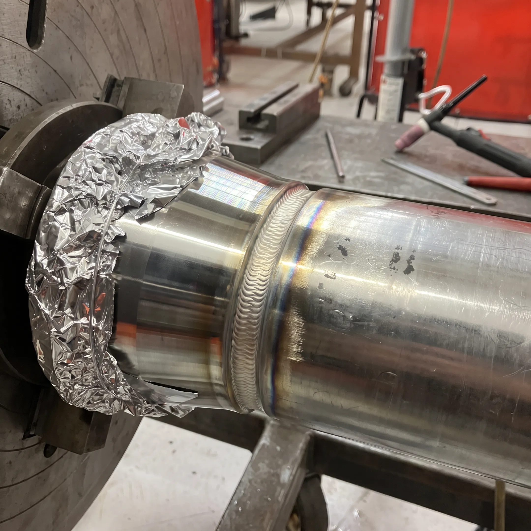 Close view of a clean aluminum TIG weld on a fabricated assembly