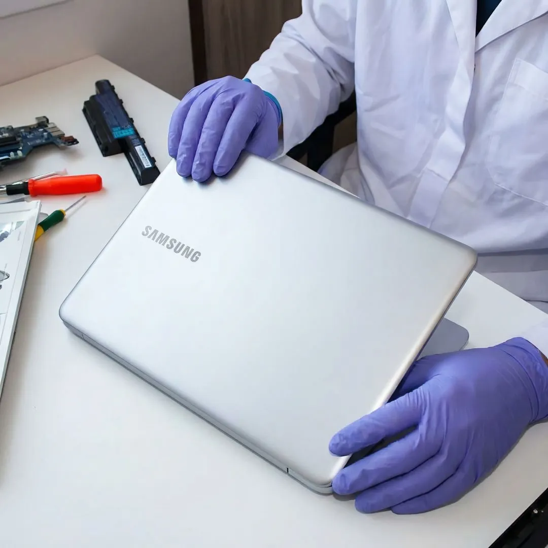 Technician repairing a Samsung laptop at a professional repair service center