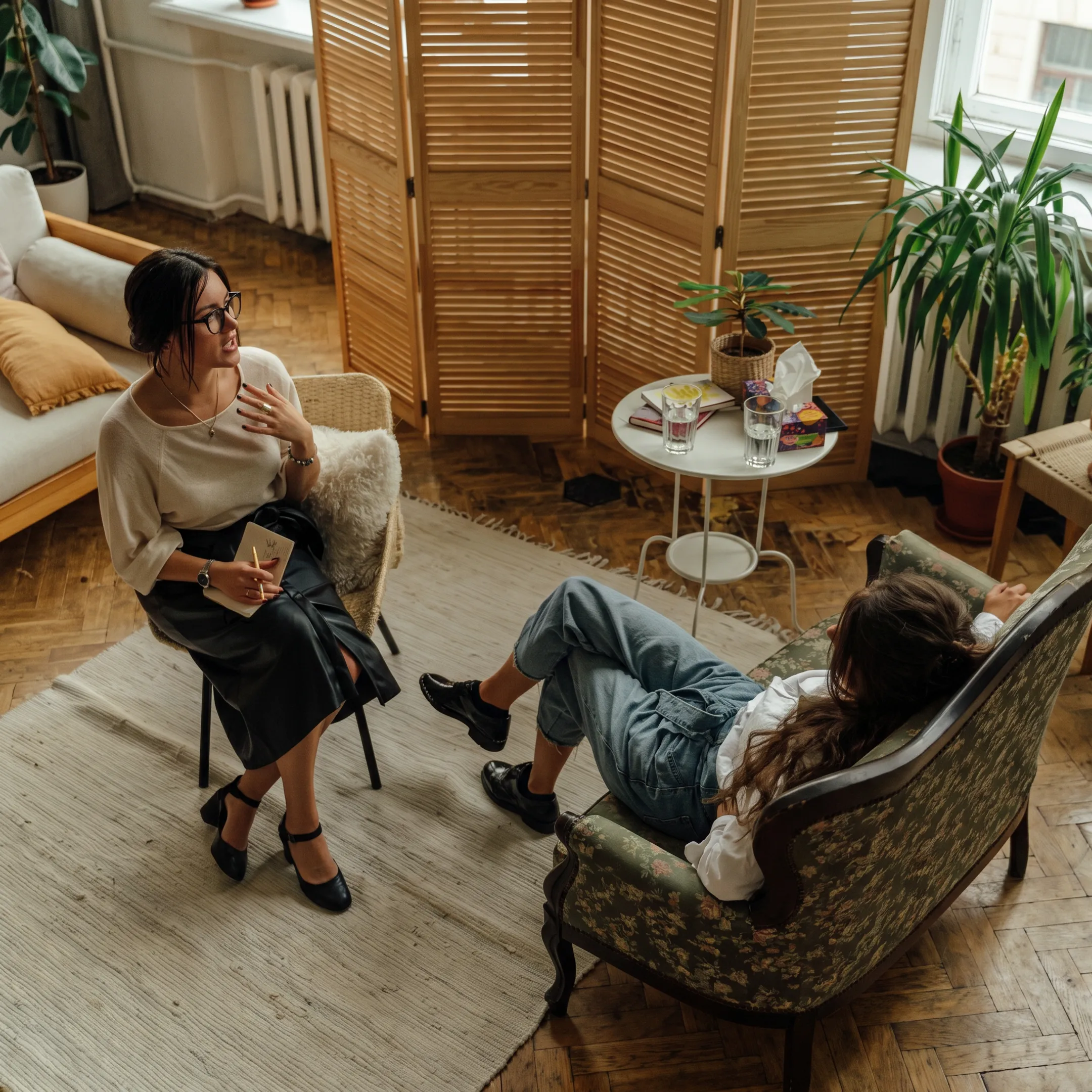 Clinician speaking with an adult client in a calm behavioral health treatment setting