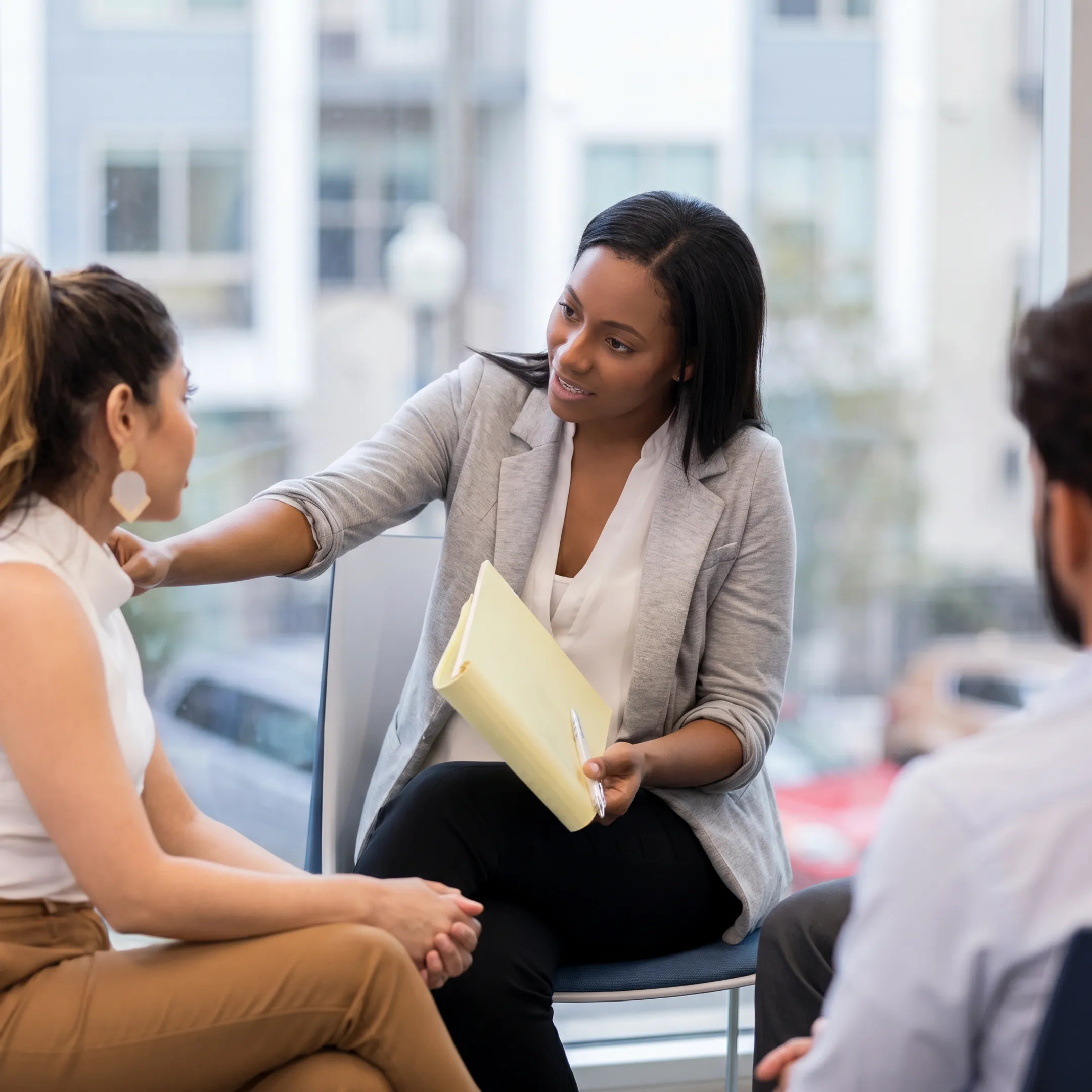 Clinician meeting with adult client during a partial hospitalization program consultation