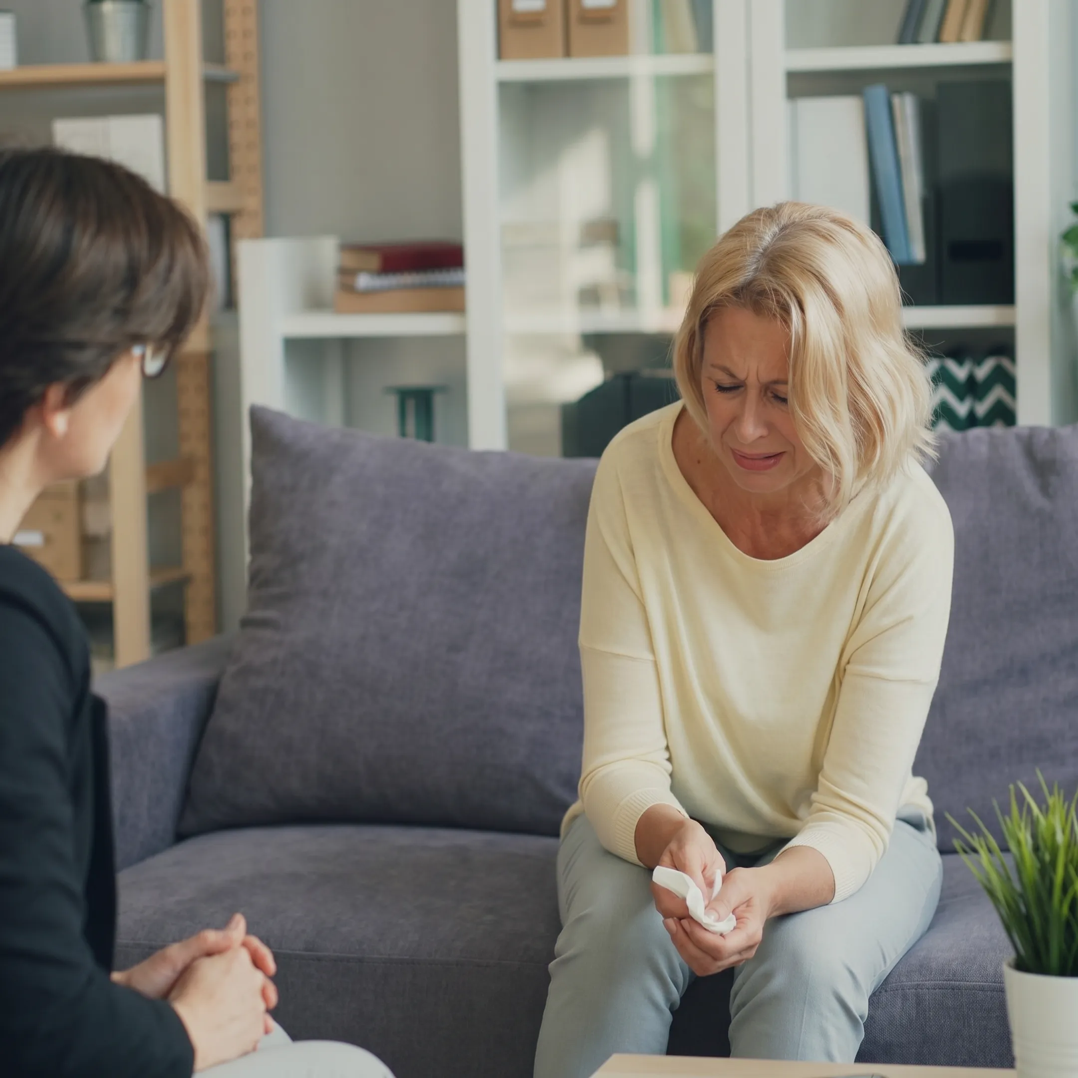 Therapist conducting a secure virtual mental health counseling session with an adult client at home