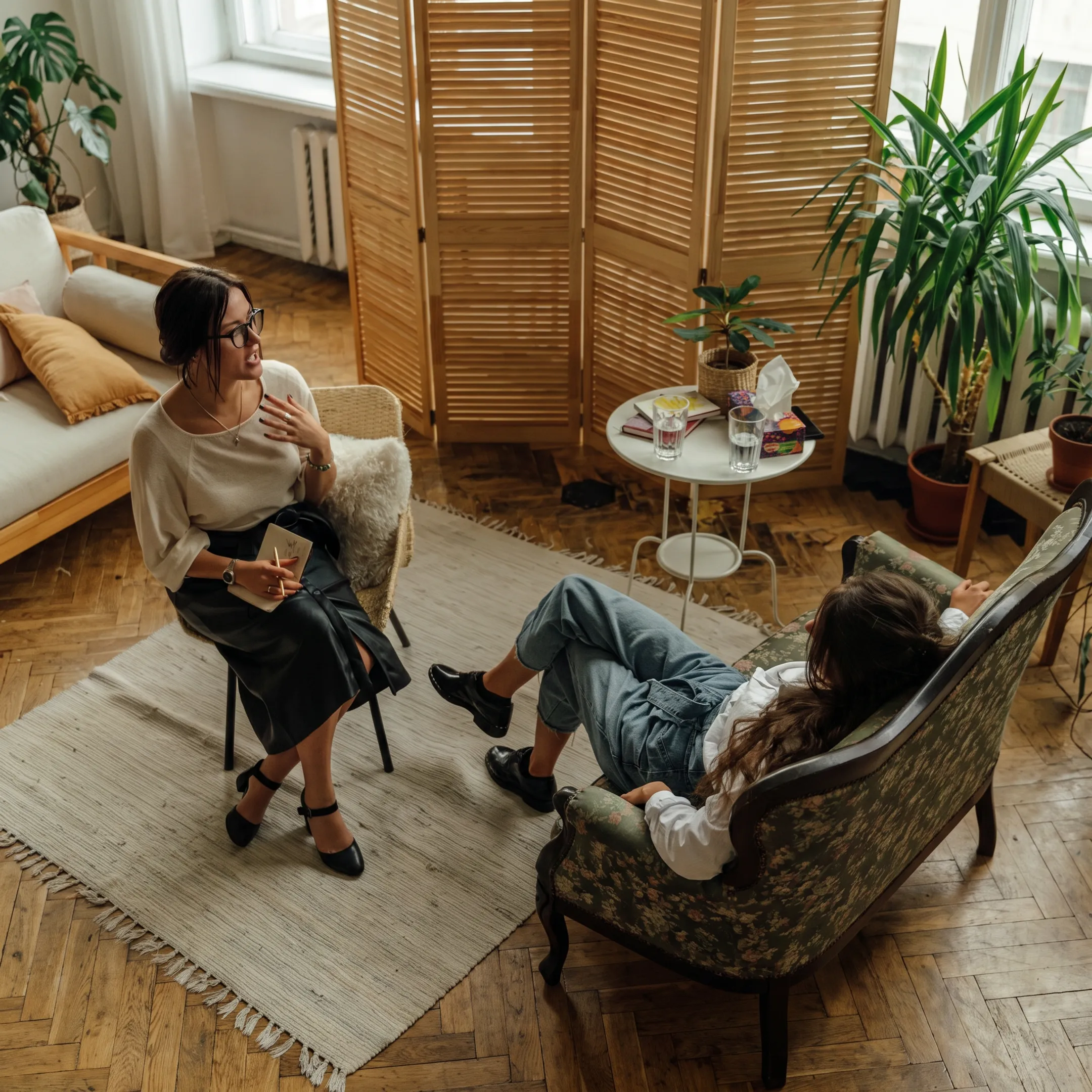 Adult client speaking with a behavioral health clinician during outpatient treatment