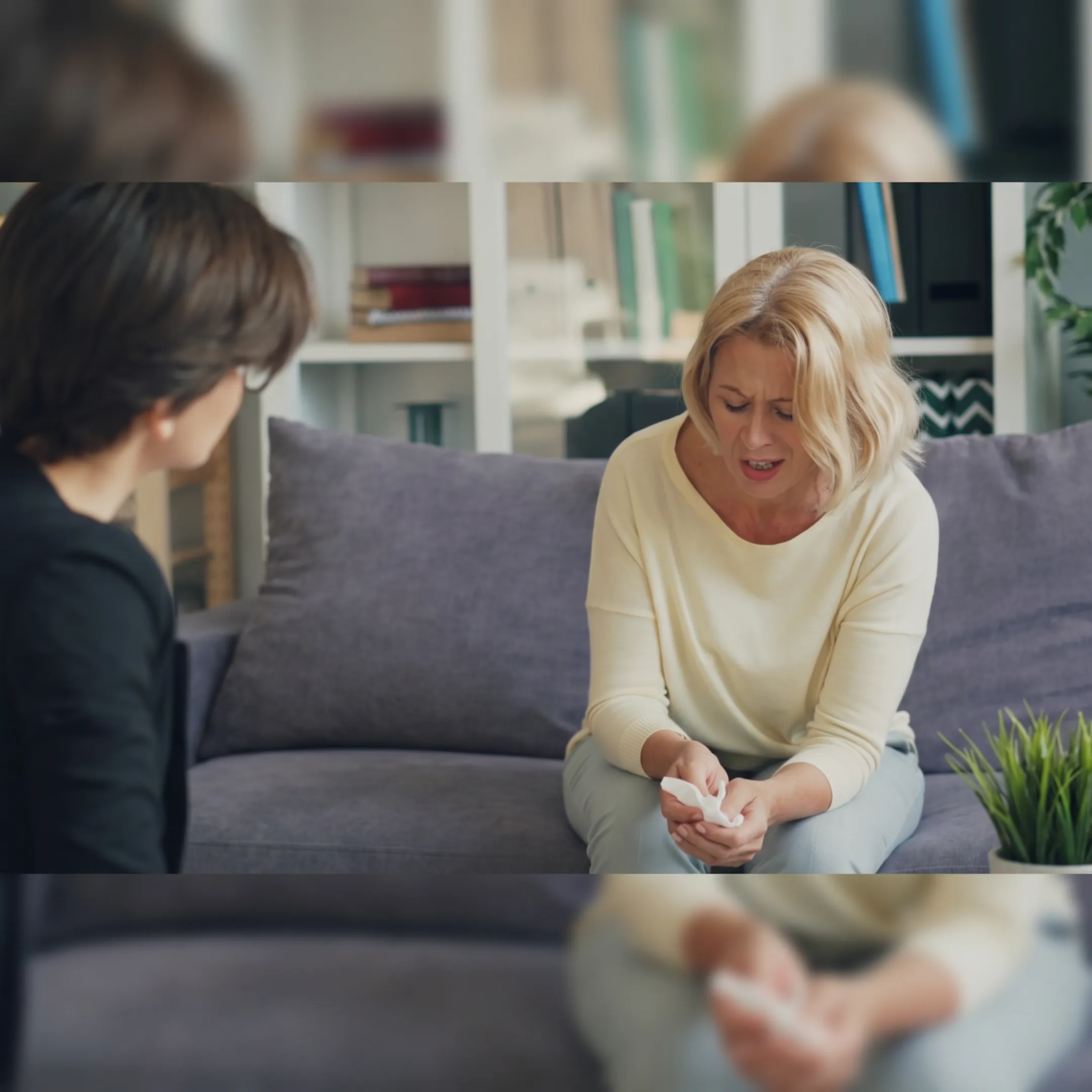 Therapist meeting with adult clients in a supportive outpatient group session