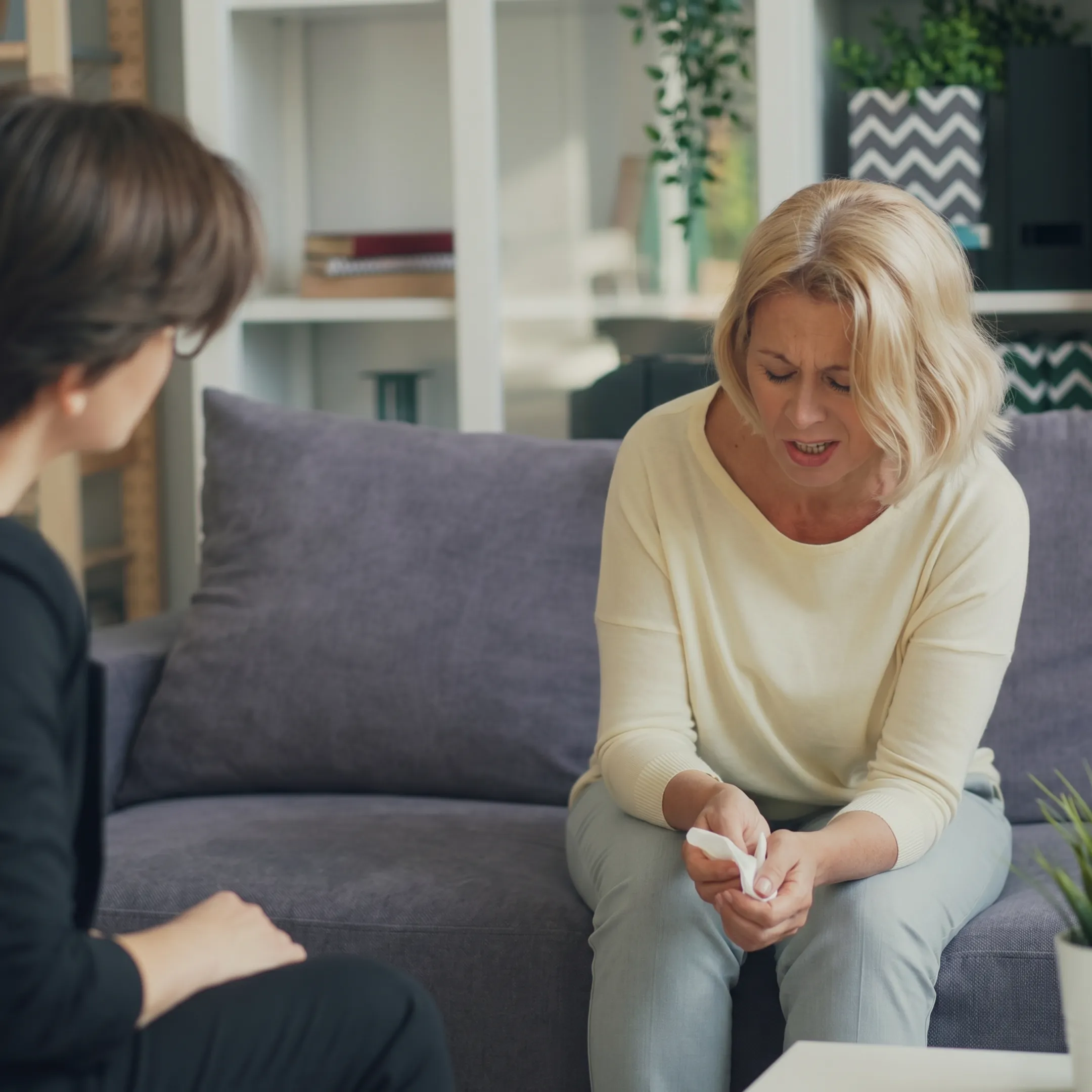 Therapist conducting a confidential online mental health consultation with an adult client
