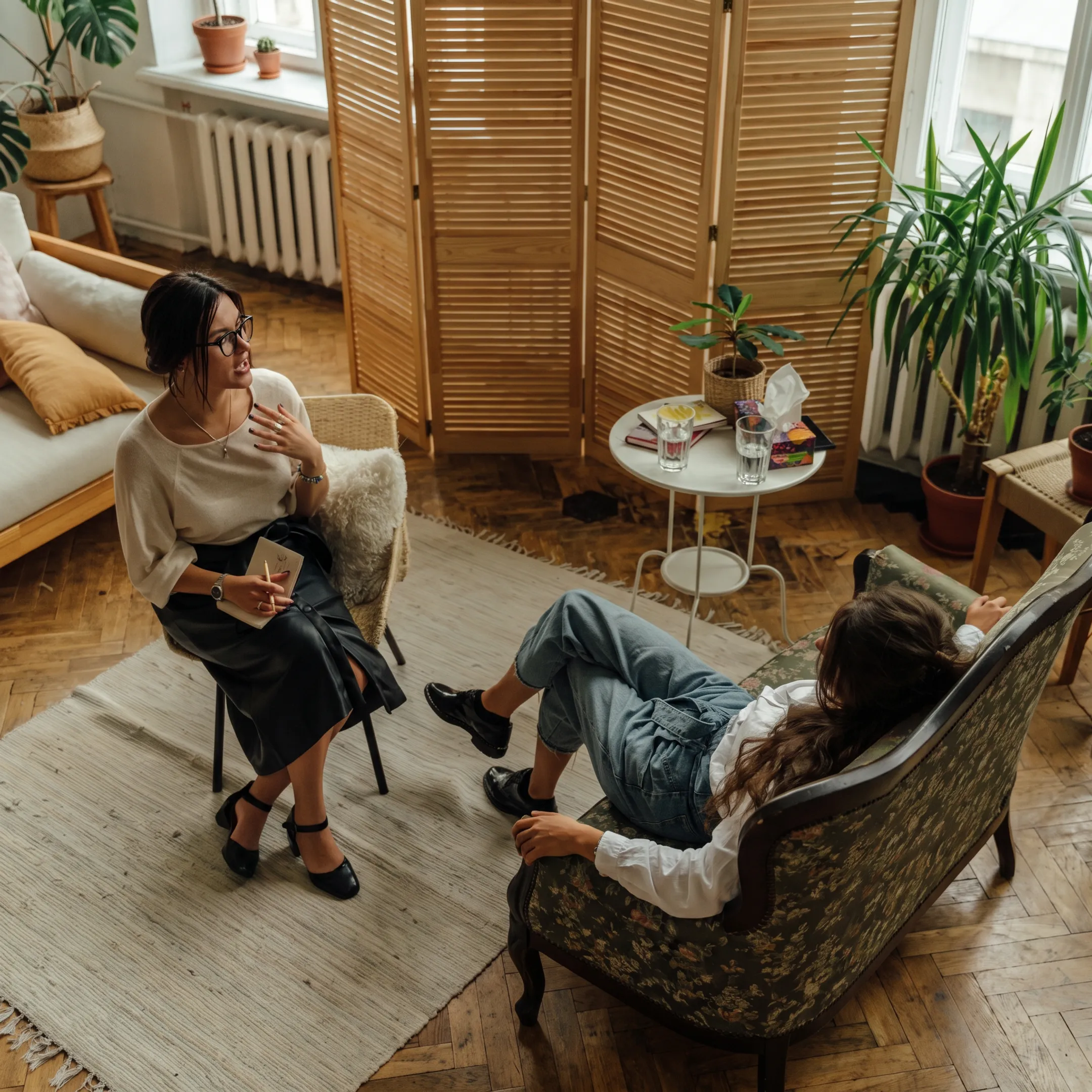 Mental health clinicians meeting with an adult in a calm residential treatment setting
