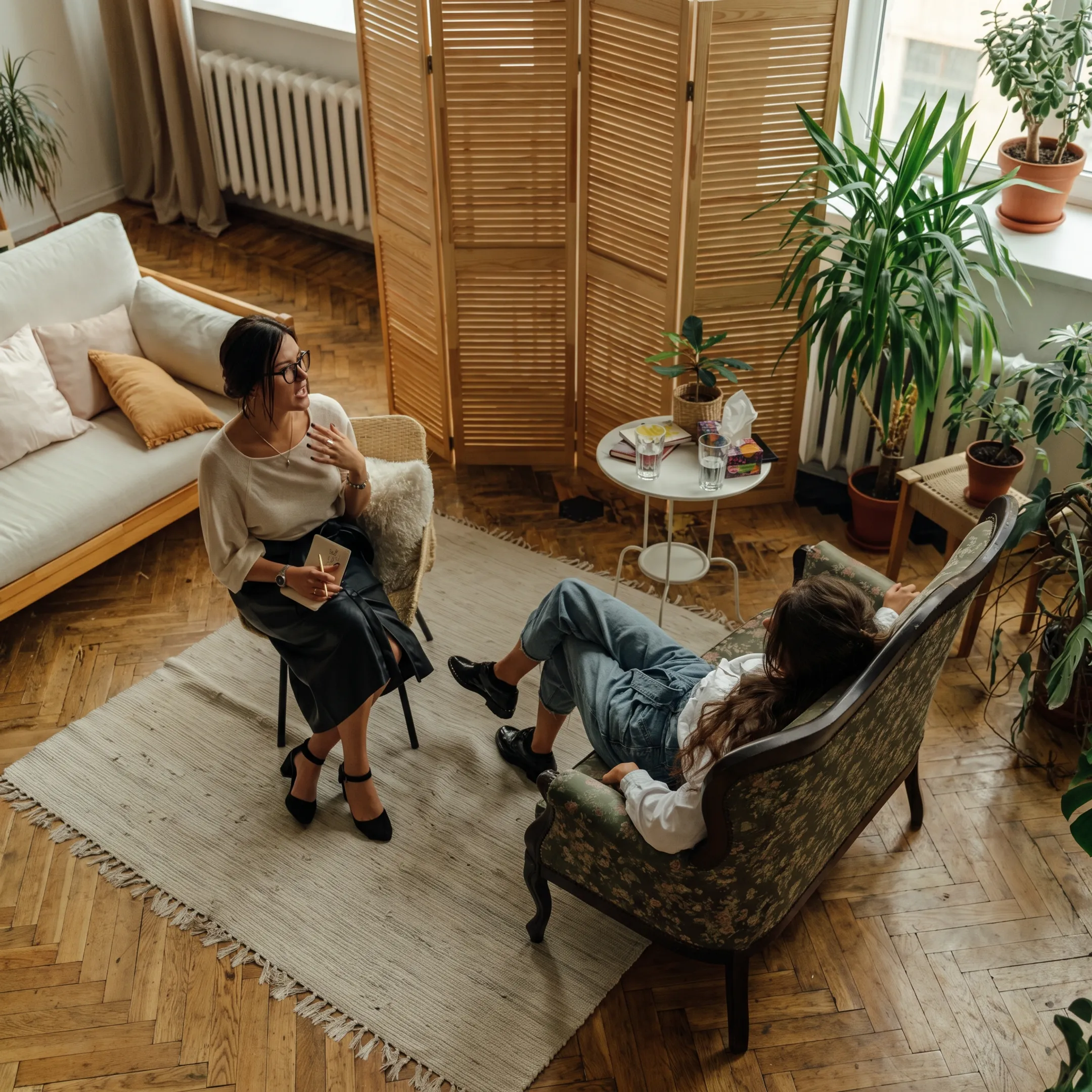 Clinician speaking with an adult in a calm behavioral health treatment setting