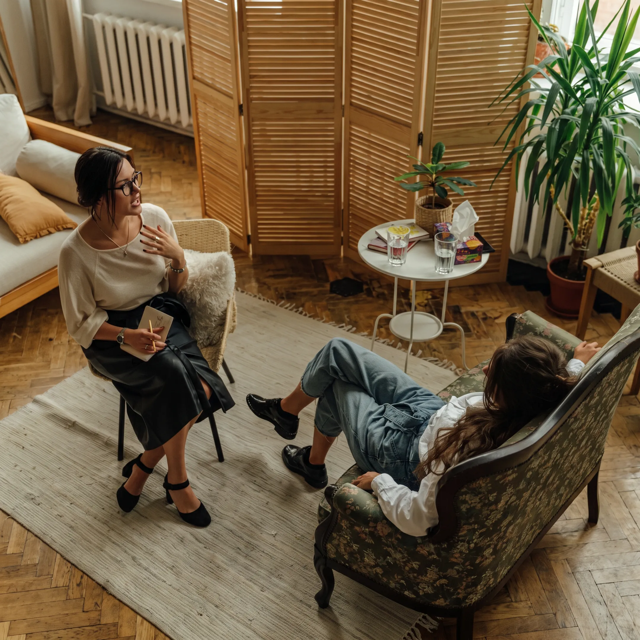 Adult client speaking with a behavioral health therapist during an individualized treatment session