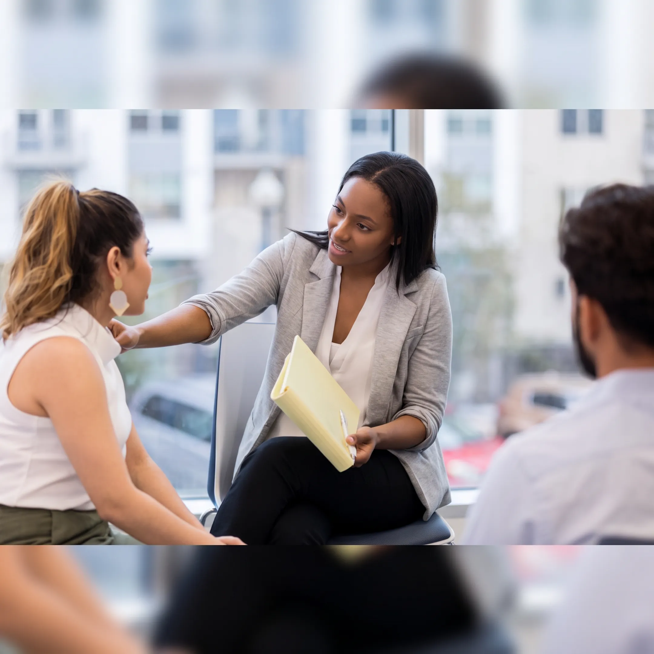 Therapist leading a DBT group session with adult clients in a calm treatment setting