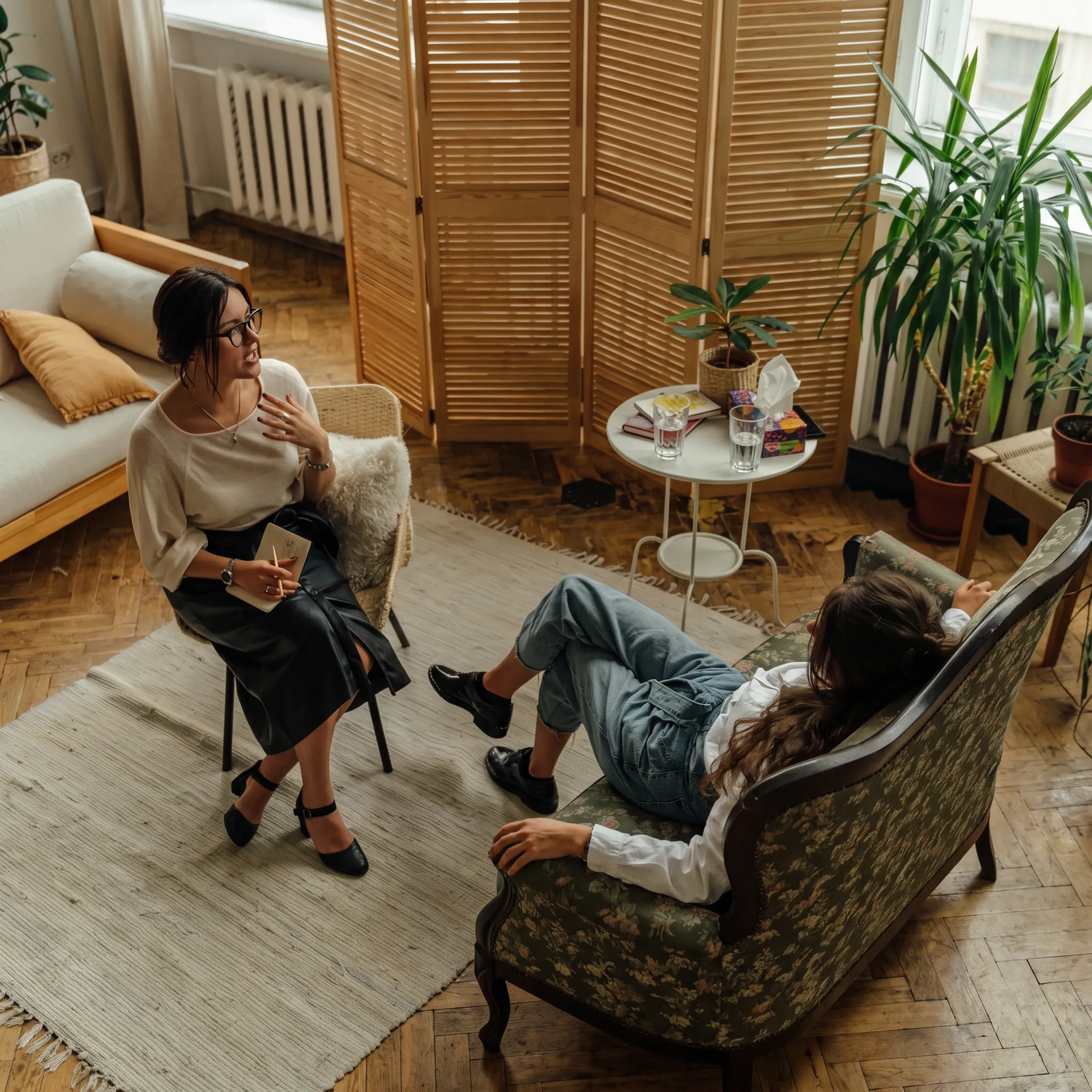 Clinician speaking with an adult patient in a calm residential mental health treatment setting