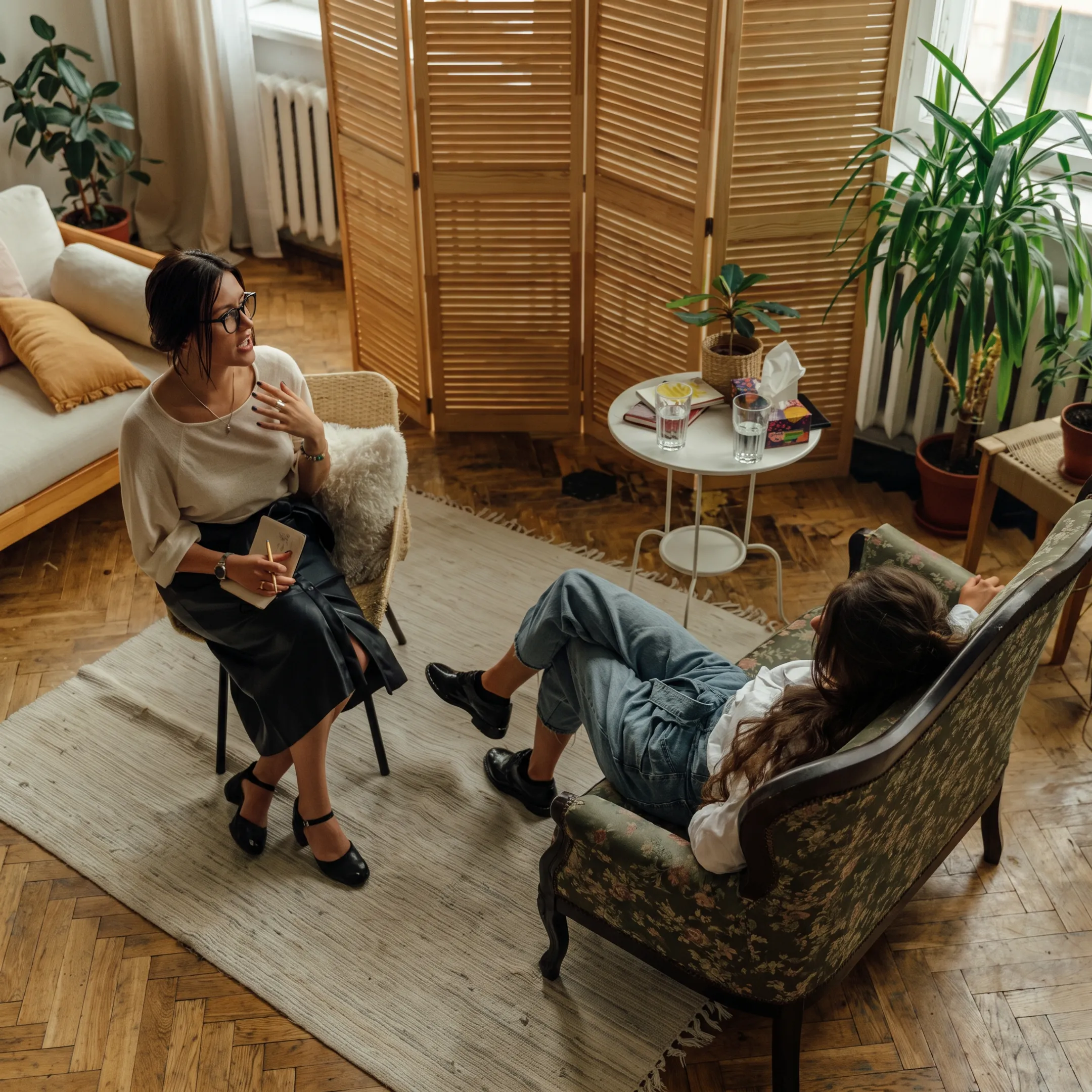 Clinician speaking with an adult in a calm residential mental health treatment setting