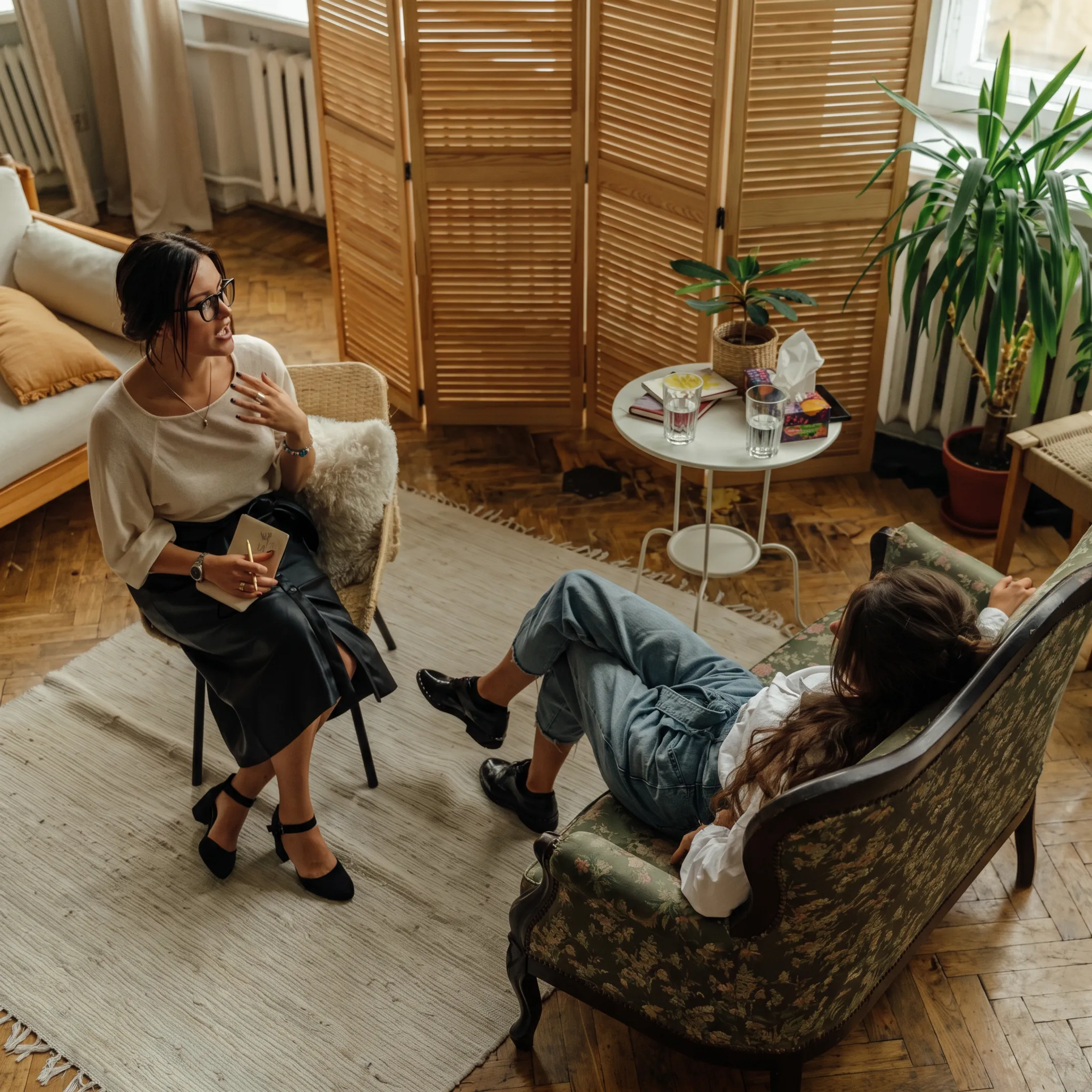Therapist speaking with adult client in a calm treatment setting