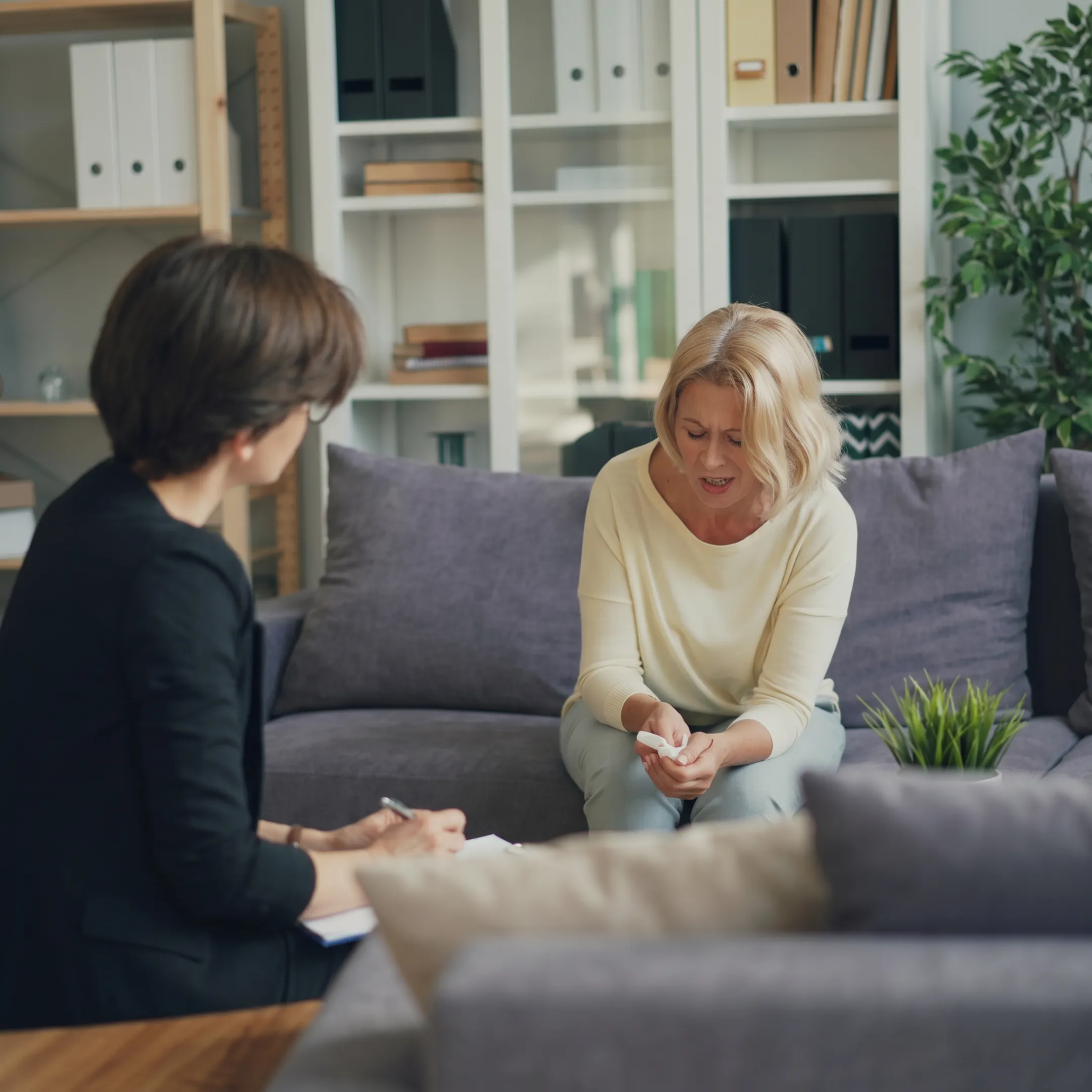 Therapist speaking with an adult client in a calm California outpatient treatment setting