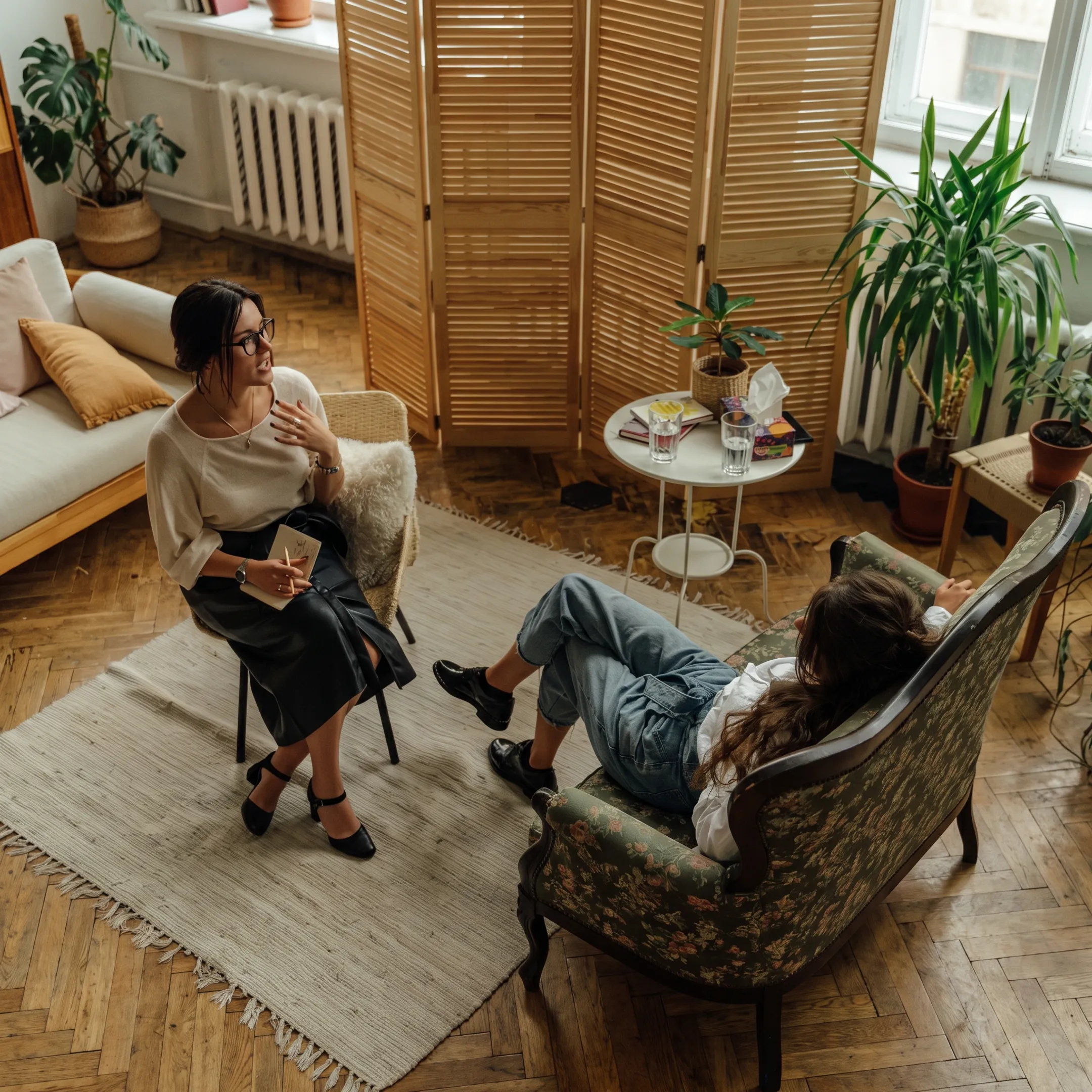 Clinician speaking with an adult client in a calm residential mental health treatment setting