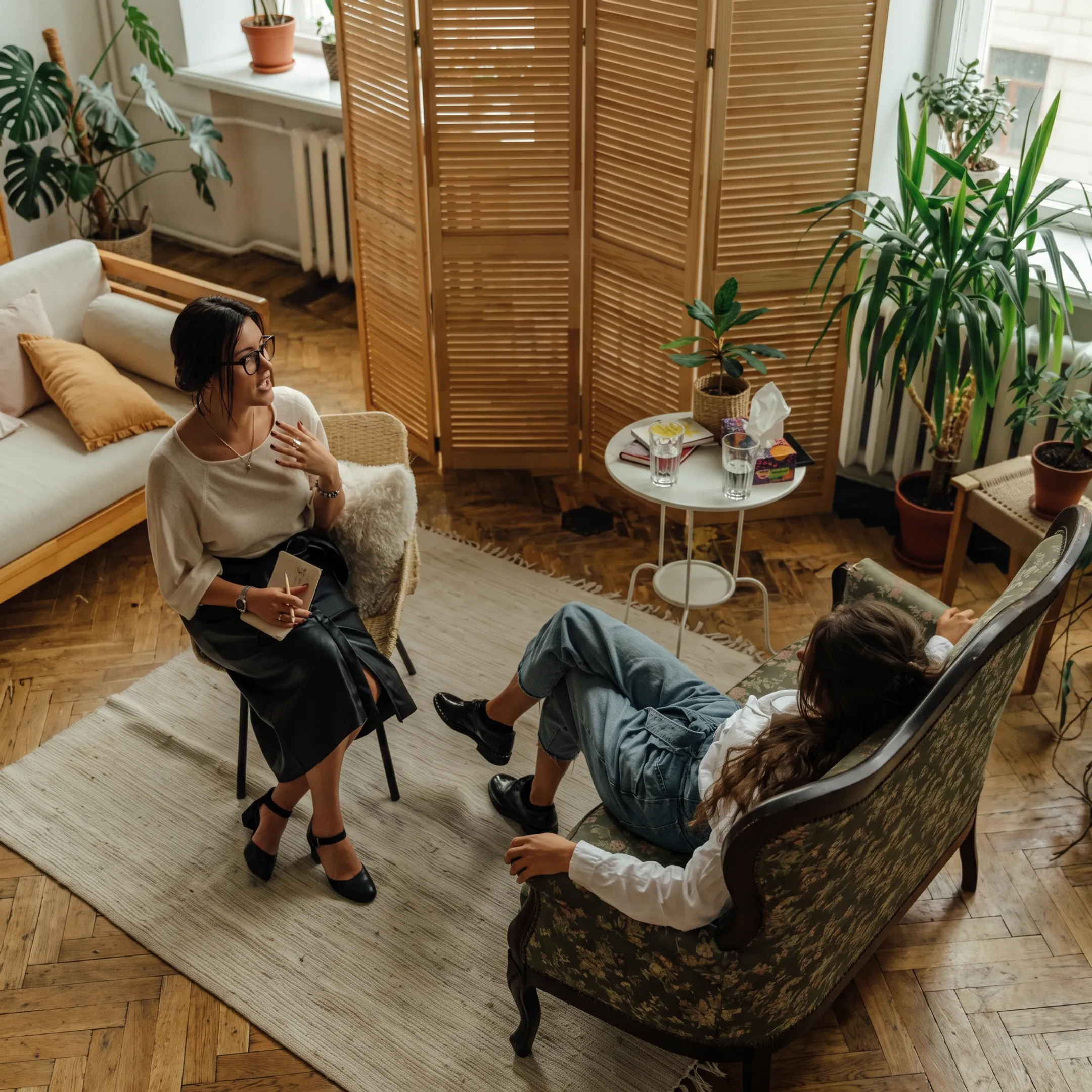 Clinician conducting a trauma-focused therapy session with an adult client