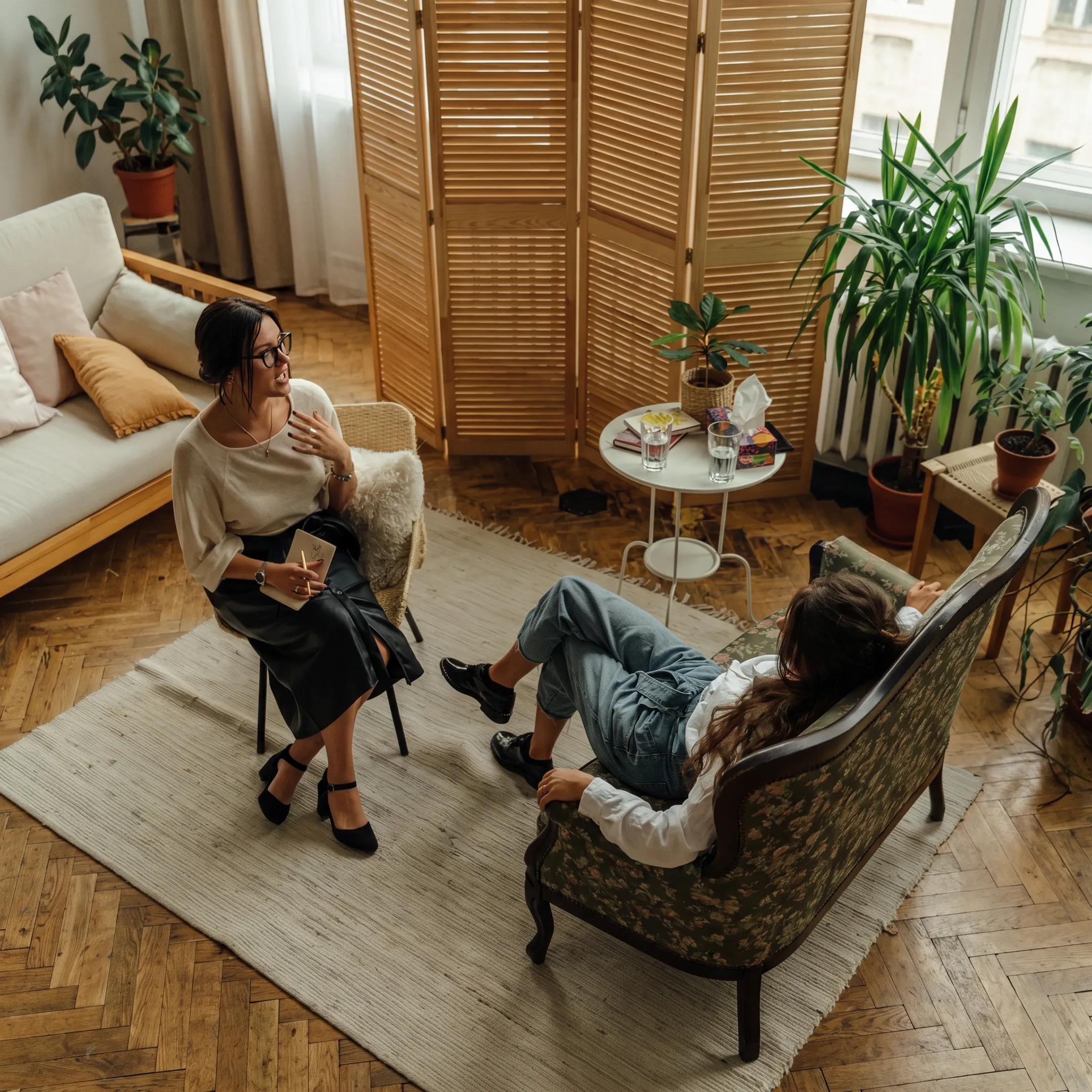 Clinician meeting with an adult client in a calm residential treatment environment
