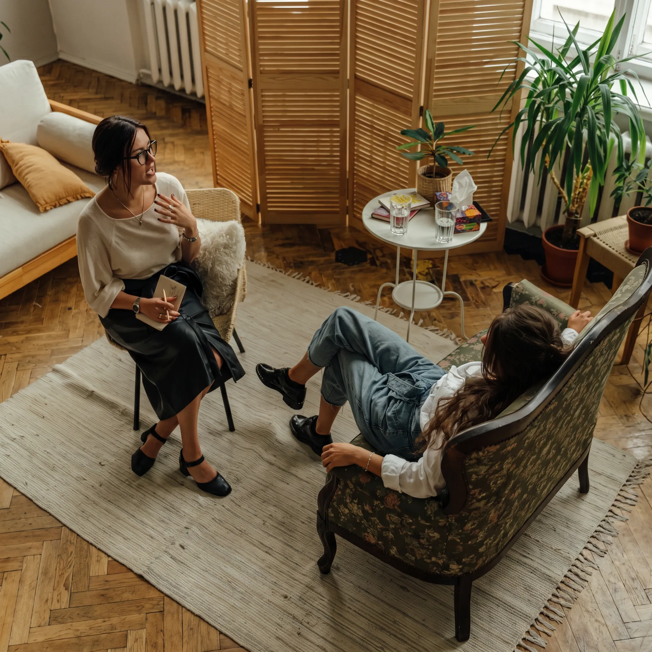 Clinician speaking supportively with an adult in a calm behavioral health setting