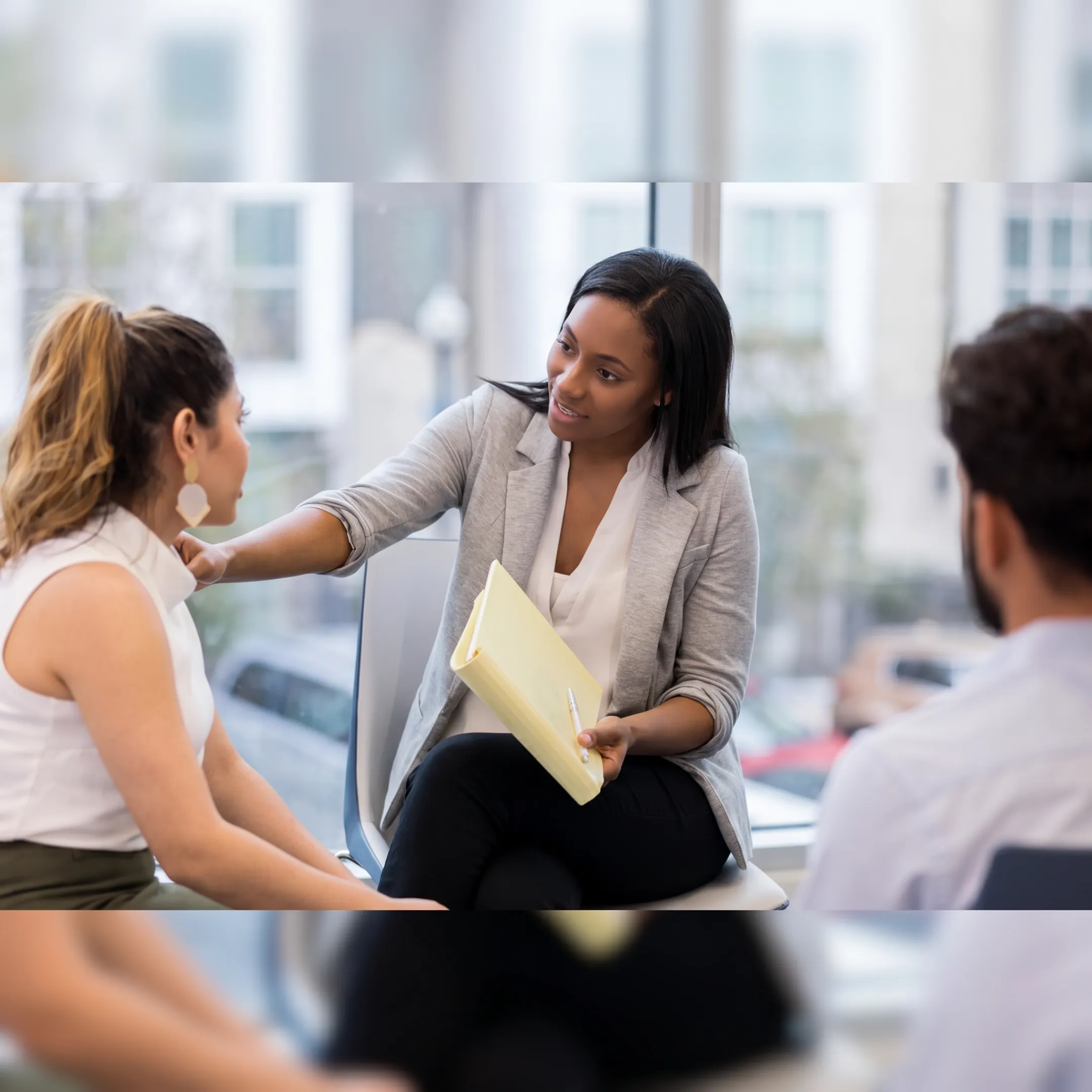 Clinician speaking with an adult client in a supportive mental health treatment setting