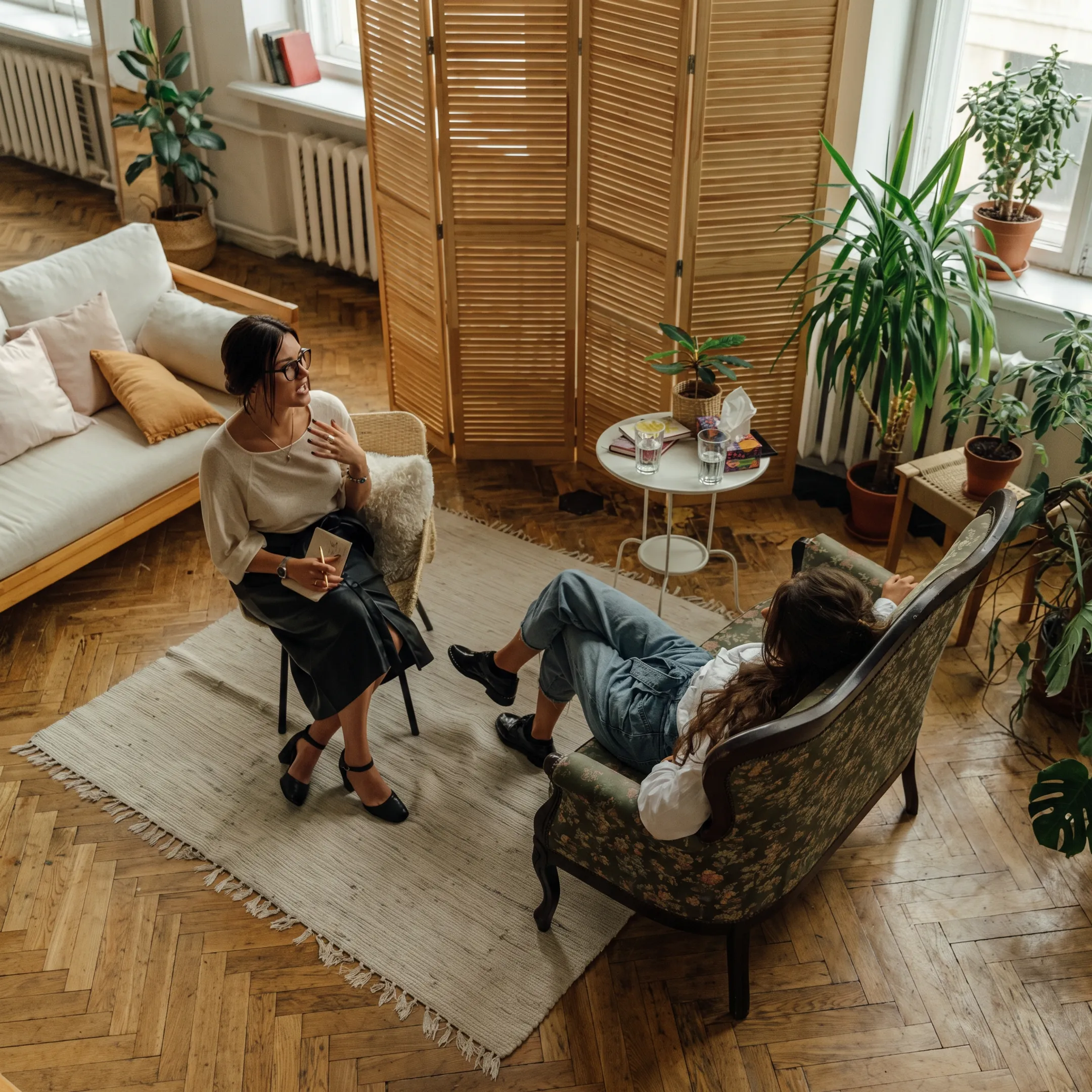Adult client speaking with a behavioral health therapist during individualized treatment