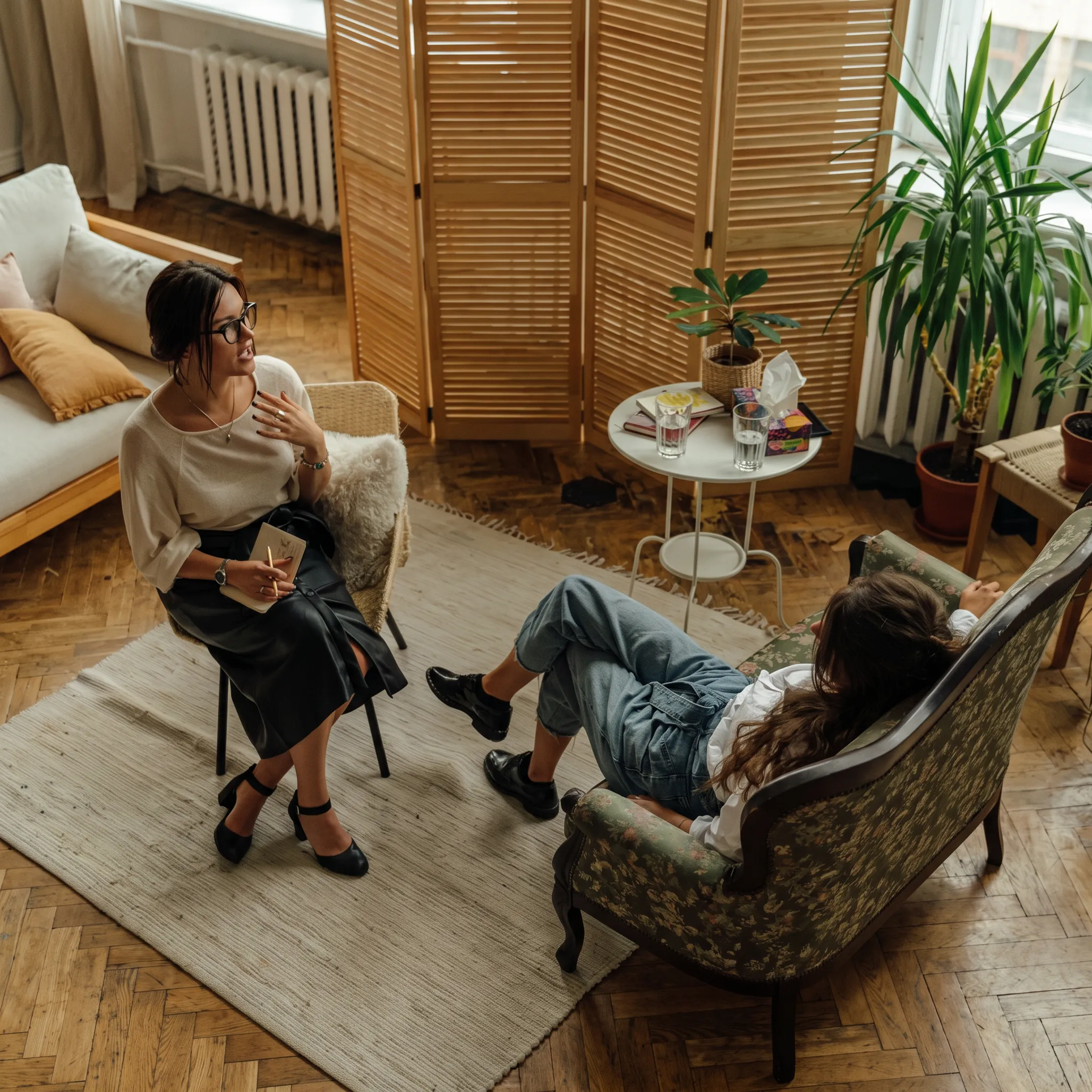 Mental health treatment team meeting with an adult client in a calm therapy setting
