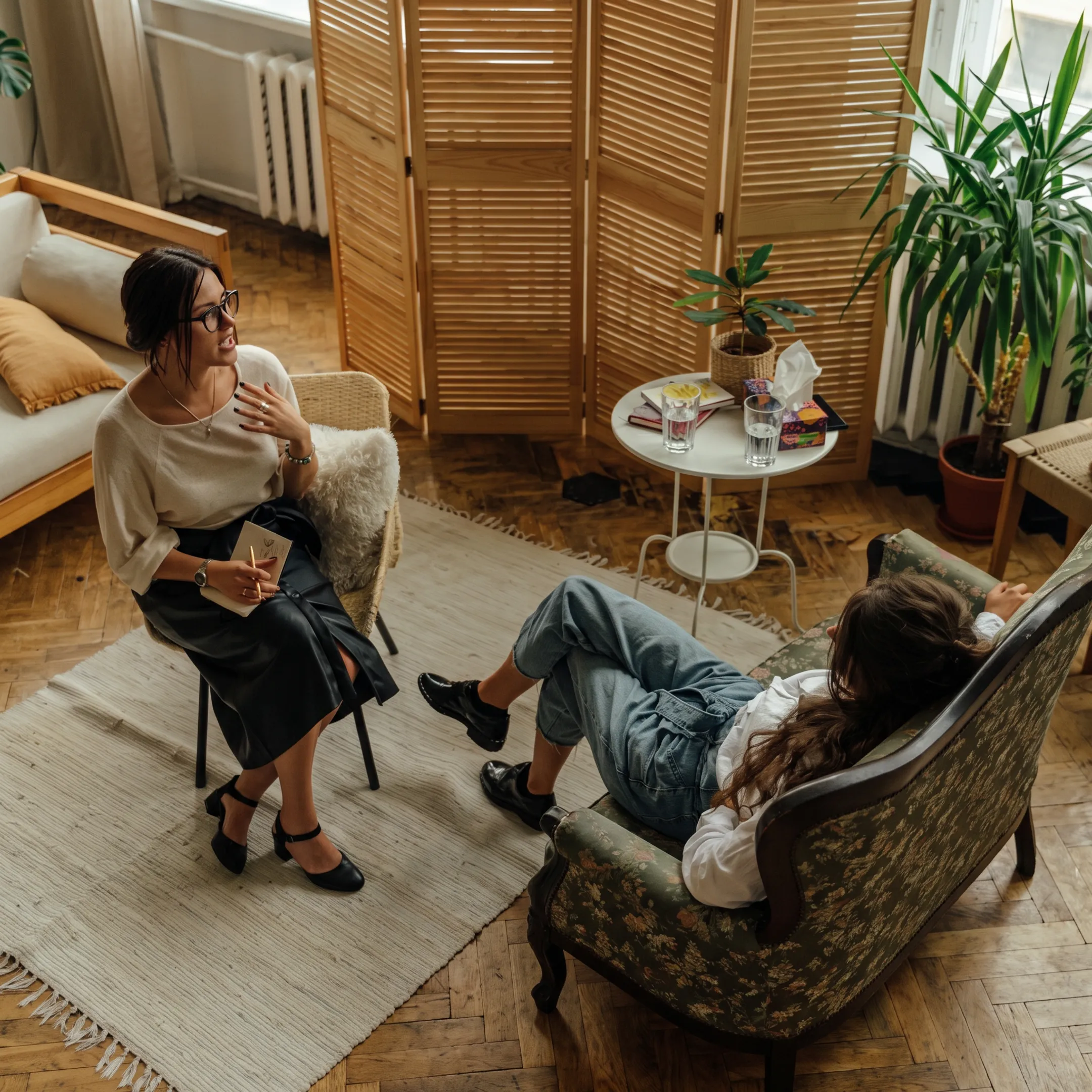 Clinician speaking with adult client in a calm California treatment setting