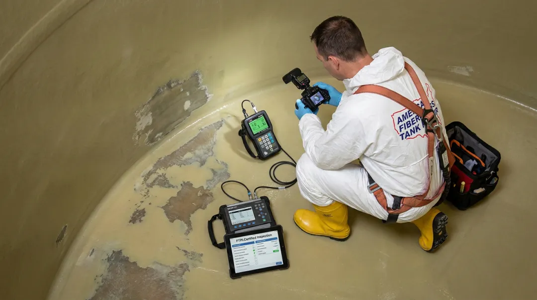 AFTR certified inspector performing non-destructive testing on fiberglass tank interior liner