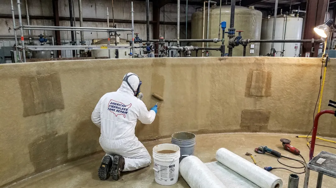 AFTR technician performing fiberglass tank liner relamination repair in field