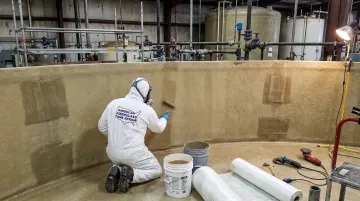 AFTR technician performing fiberglass tank liner relamination repair in field