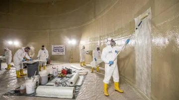 AFTR field crew applying fiberglass laminate to industrial tank on job site