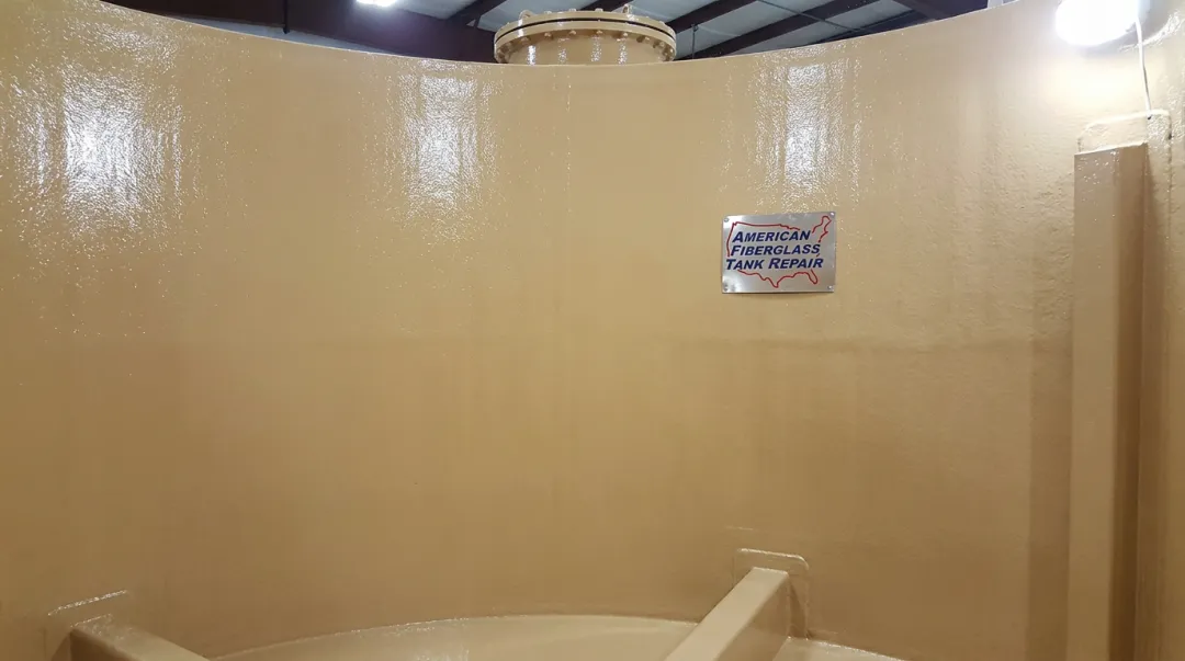 Internal FRP tank relining process showing restored corrosion barrier vinylester application