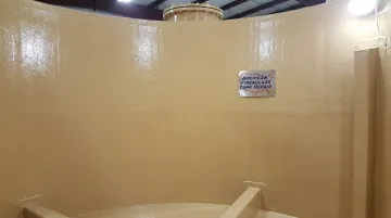 Internal FRP tank relining process showing restored corrosion barrier vinylester application